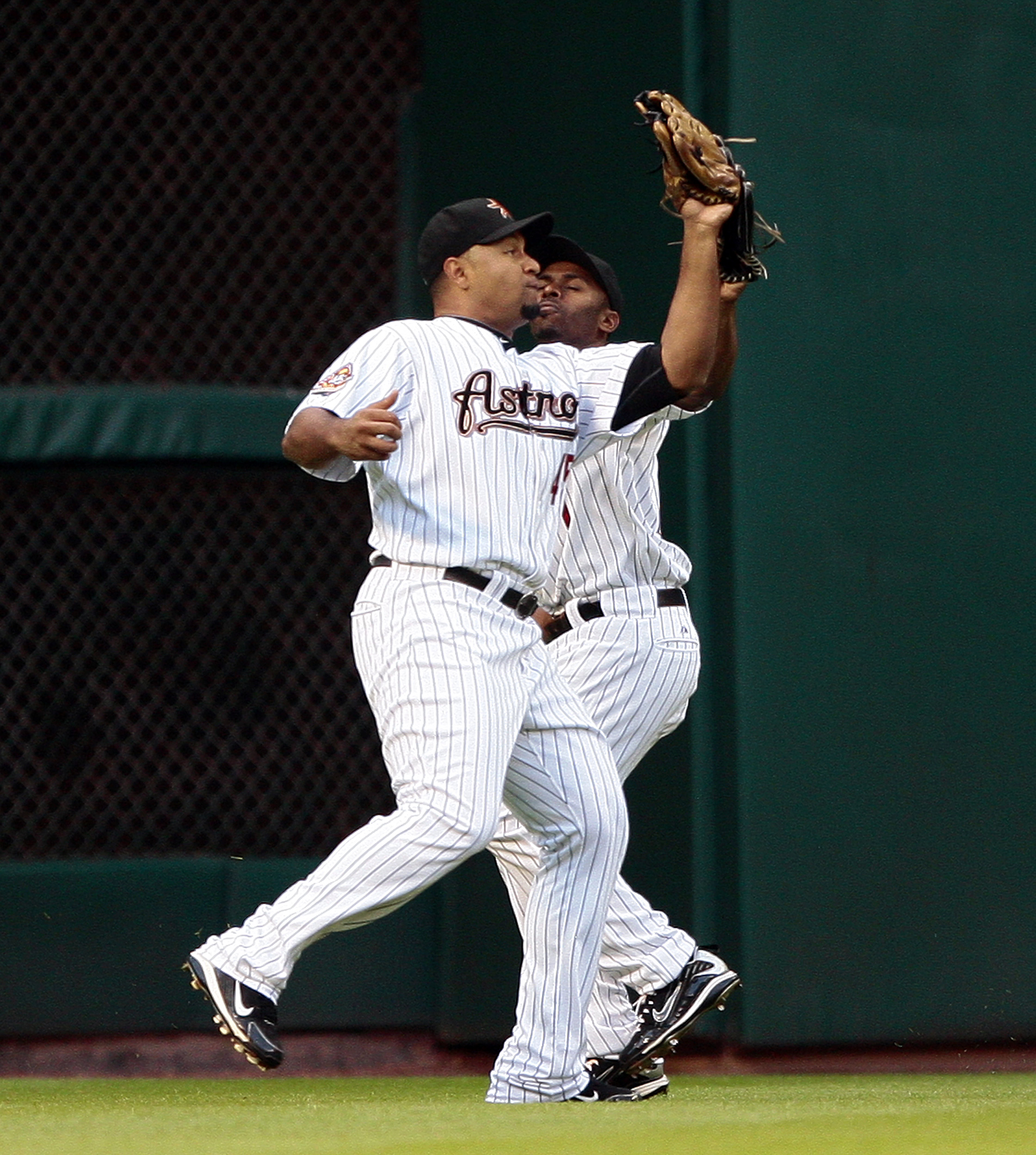 Houston Astros left fielder Carlos Lee misplays a ball hit by the