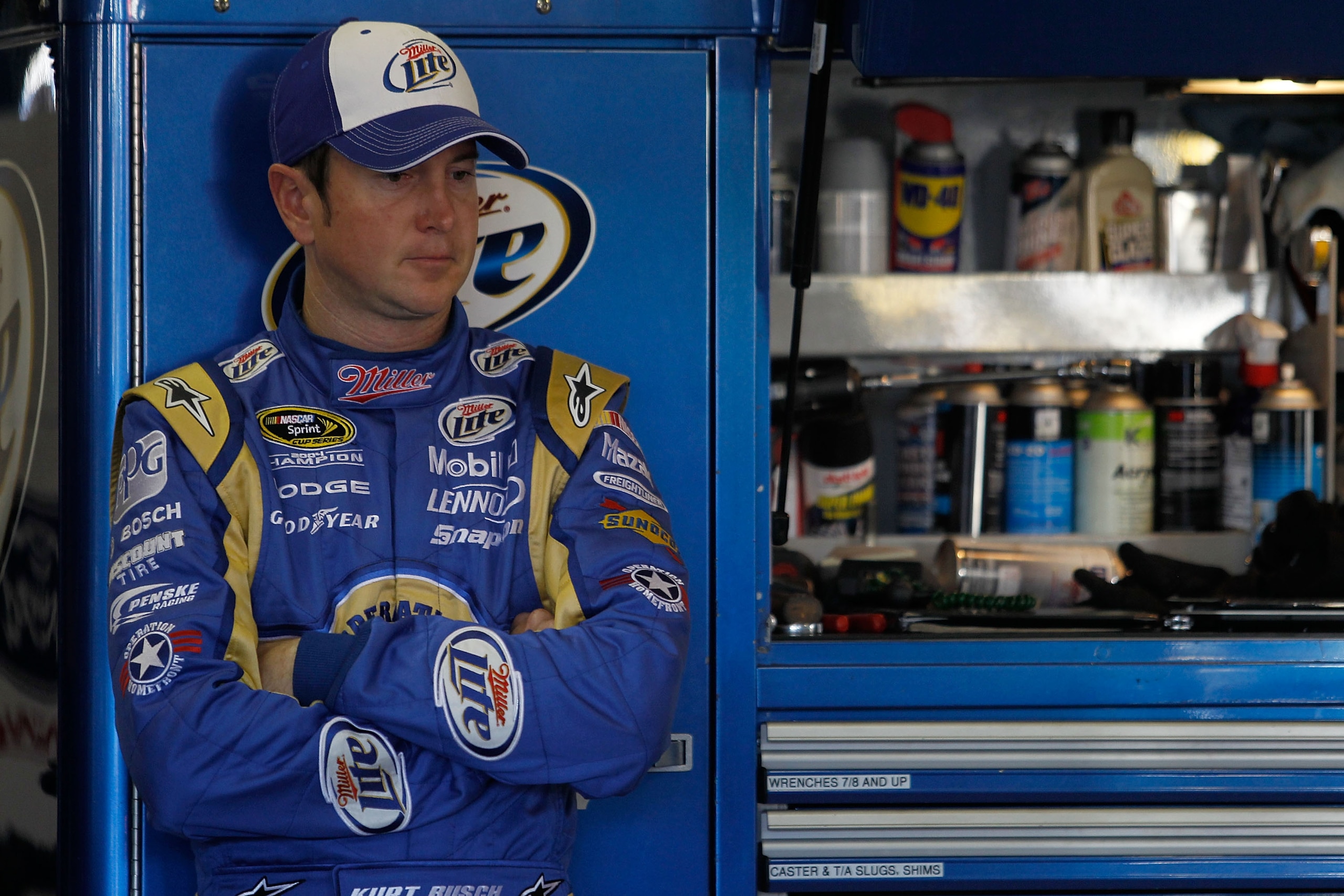 FORT WORTH, TX - NOVEMBER 06:  Kurt Busch, driver of the #2 Operation Home Front/Miller Lite Dodge, stands in the garage area during practice for the NASCAR Sprint Cup Series AAA Texas 500 at Texas Motor Speedway on November 6, 2010 in Fort Worth, Texas.
