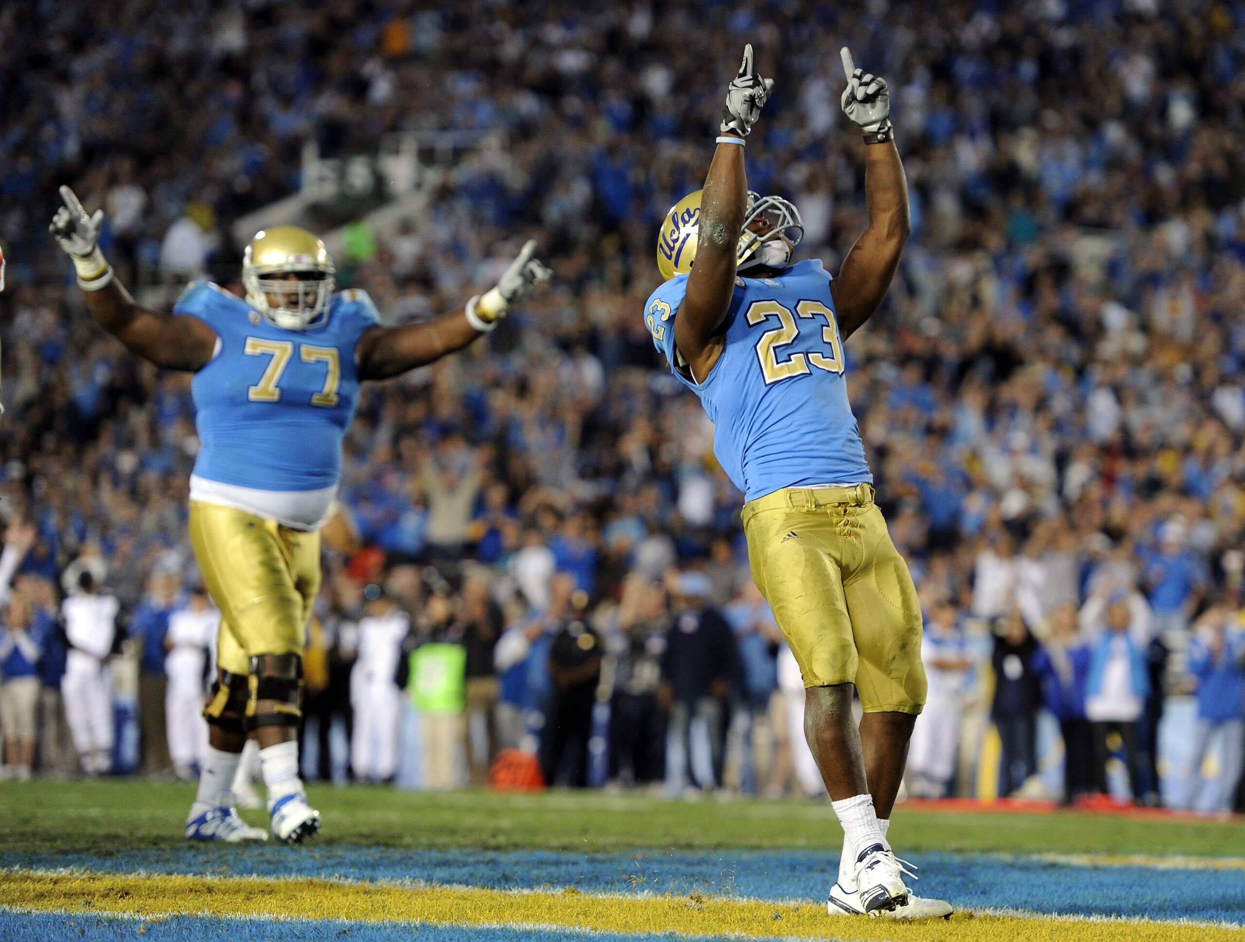 PASADENA, CA - NOVEMBER 06:  Jonathan Franklin #23 of the UCLA Bruins celebrates his touchdown with Darius Savage #77 to tie the Oregon State Beavers 14-14 during the third quarter at the Rose Bowl on November 6, 2010 in Pasadena, California.  (Photo by H