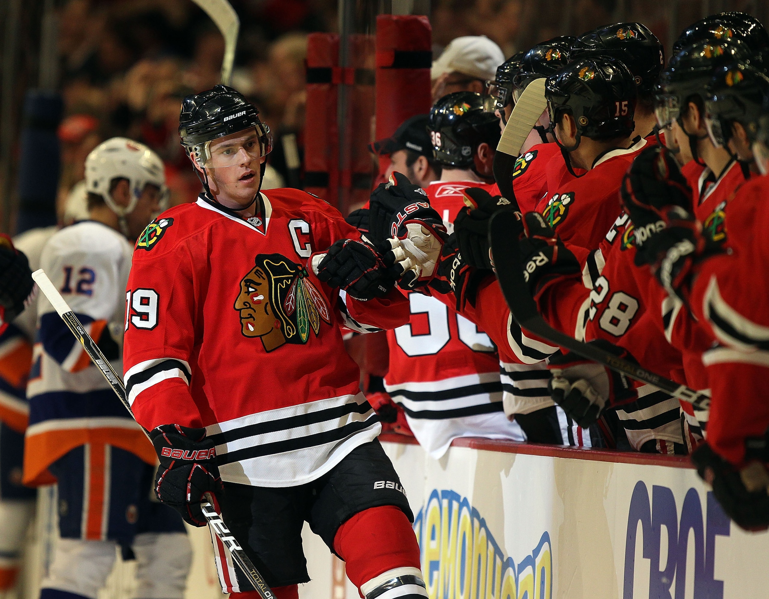 CHICAGO, IL - JANUARY 09: Jonathan Toews #19 of the Chicago Blackhawks is congratulated by teammates after a goal was scored by Patrick Sharp against the New York Islanders at the United Center on January 9, 2011 in Chicago, Illinois. The Blackhawks defea