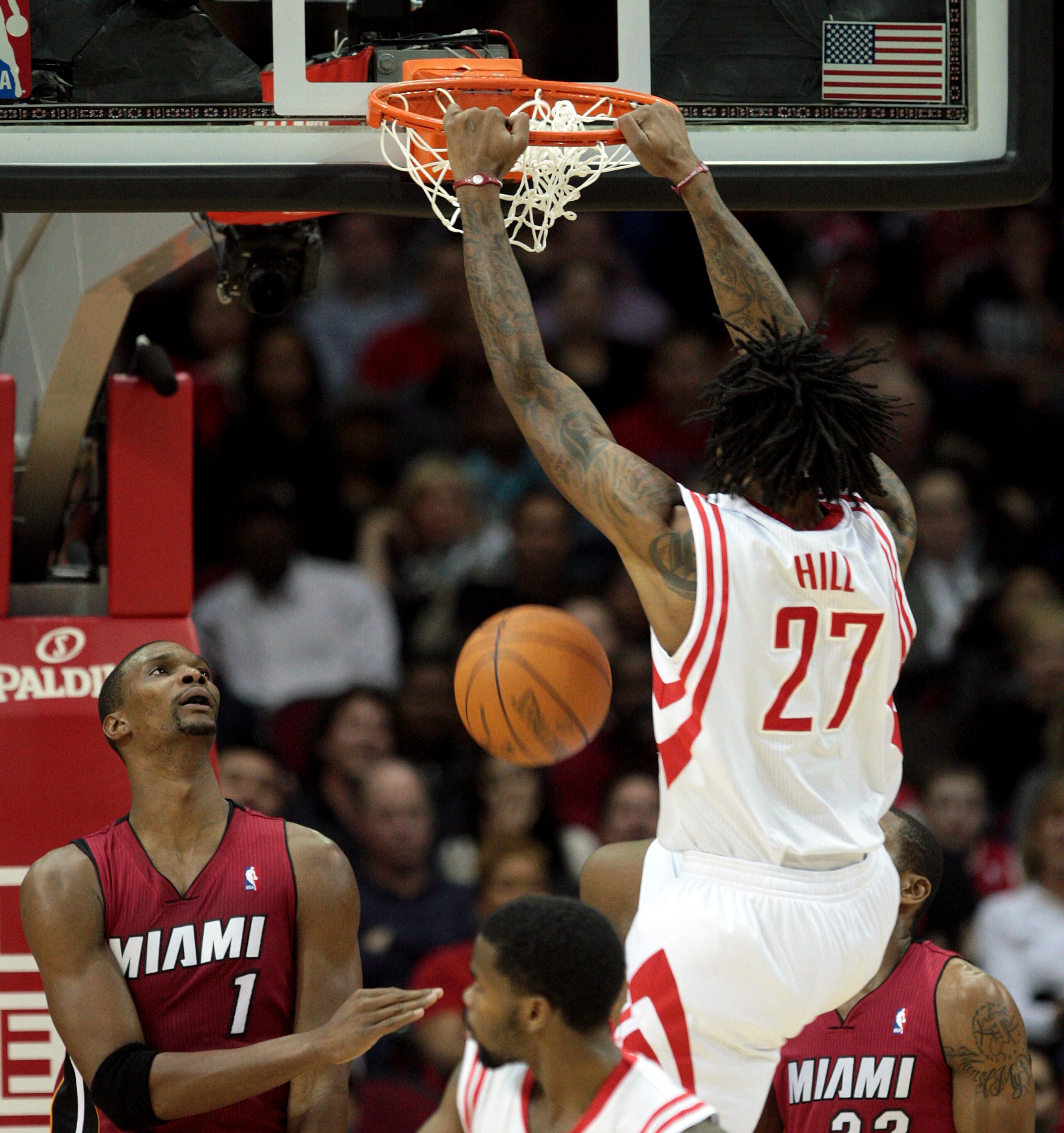 HOUSTON - DECEMBER 29: Jordan Hill #27 of the Houston Rockets dunks over Chris Bosh #1 of the Miami Heat in the first half at Toyota Center on December 29, 2010 in Houston, Texas. NOTE TO USER: User expressly acknowledges and agrees that, by downloadin HOUSTON - DECEMBER 29: Jordan Hill #27 of the Houston Rockets dunks over Chris Bosh #1 of the Miami Heat in the first half at Toyota Center on December 29, 2010 in Houston, Texas. NOTE TO USER: User expressly acknowledges and agrees that, by downloadin