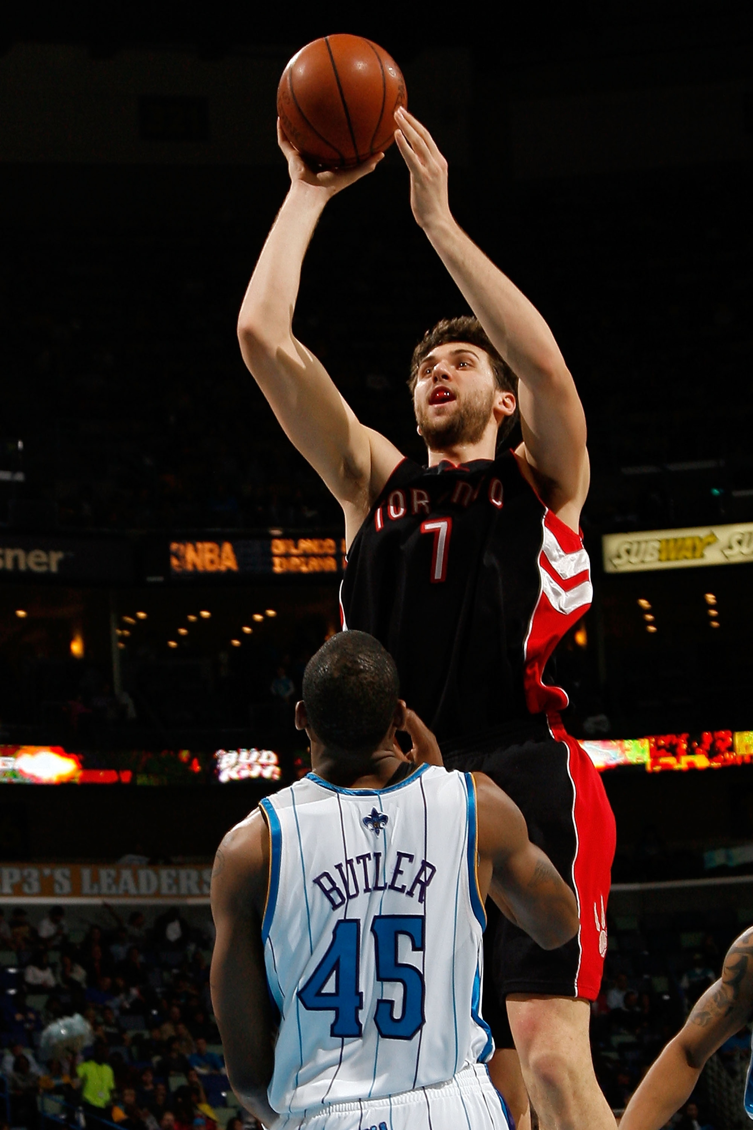 NEW ORLEANS - FEBRUARY 06: Andrea Bargnani #7 of the Toronto Raptors makes a shot over Rasual Butler #45 of the New Orleans Hornets on February 6, 2009 in New Orleans, Louisiana. The Hornets defeated the Raptors 101-92. NOTE TO USER: User expressly ack NEW ORLEANS - FEBRUARY 06: Andrea Bargnani #7 of the Toronto Raptors makes a shot over Rasual Butler #45 of the New Orleans Hornets on February 6, 2009 in New Orleans, Louisiana. The Hornets defeated the Raptors 101-92. NOTE TO USER: User expressly ack