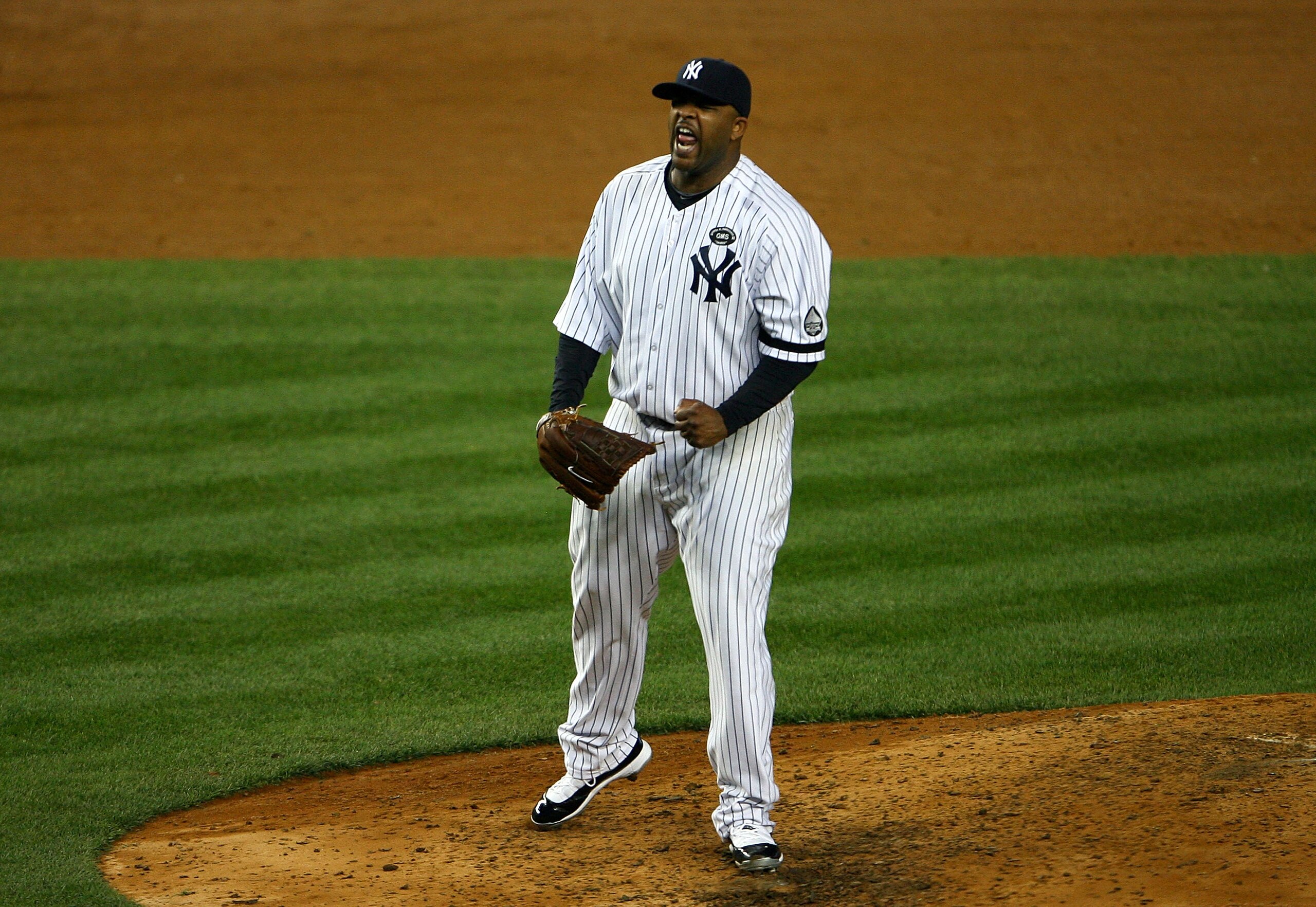 NEW YORK - OCTOBER 20:  CC Sabathia #52 of the New York Yankees reacts after he struck out Mitch Moreland #18 of the Texas Rangers to end the top of the sixth inning of Game Five of the ALCS during the 2010 MLB Playoffs at Yankee Stadium on October 20, 20