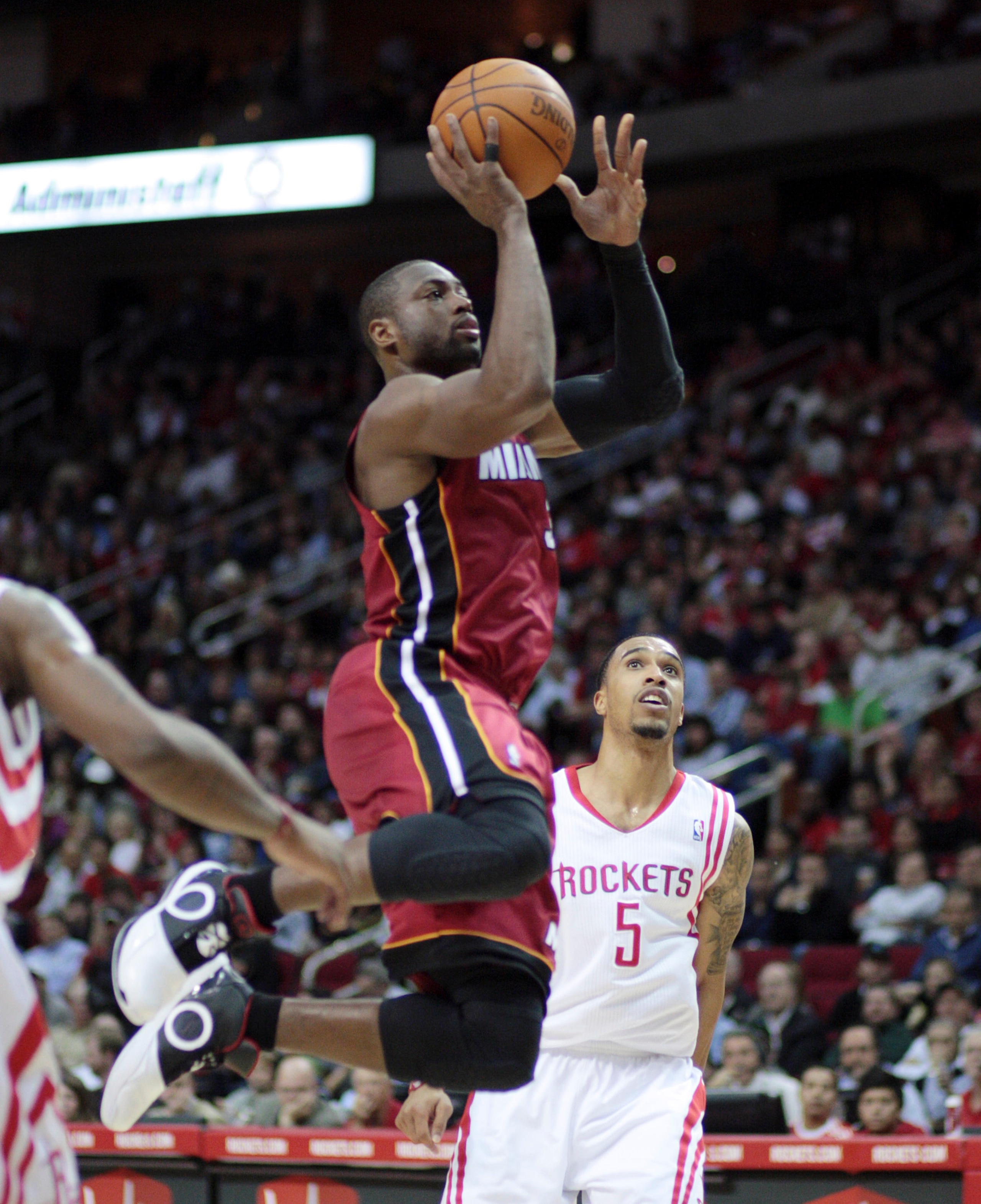 HOUSTON - DECEMBER 29:  Dwyane Wade #3 of the Miami Heat drives past Houston Rockets'  Courtney Lee #5 in the first half at Toyota Center on December 29, 2010 in Houston, Texas.  NOTE TO USER: User expressly acknowledges and agrees that, by downloading an