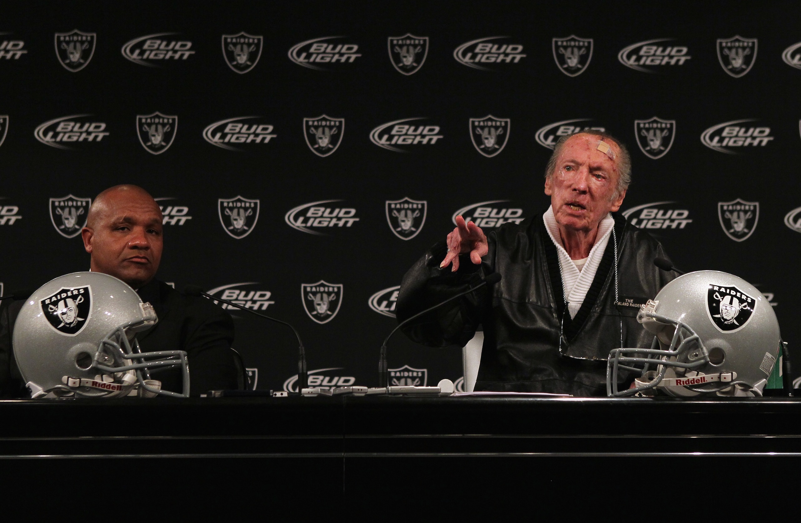 ALAMEDA, CA - JANUARY 18:  New Oakland Raiders coach Hue Jackson (L) looks on as Raiders owner Al Davis speaks during a press conference on January 18, 2011 in Alameda, California. Hue Jackson was introduced as the new coach of the Oakland Raiders, replac