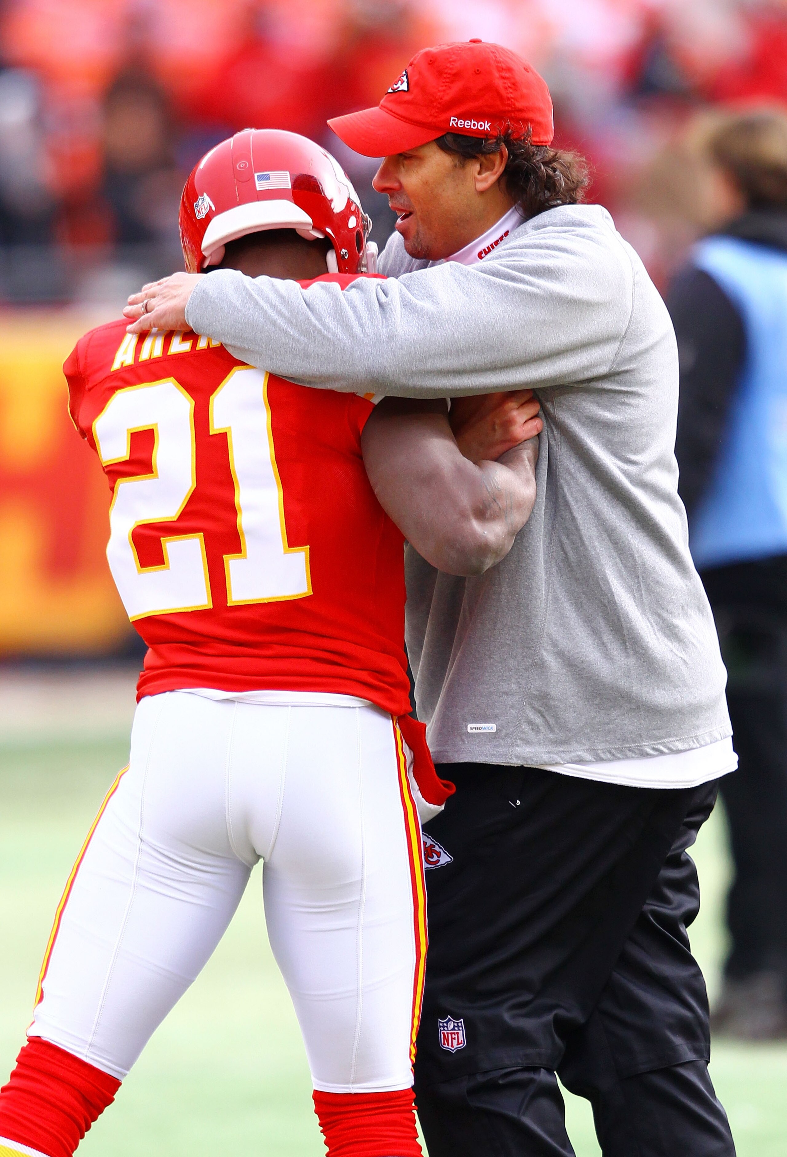 KANSAS CITY, MO - JANUARY 09:  Head coach Todd Haley of the Kansas City Chiefs hugs cornerback Javier Arenas #21 prior to the 2011 AFC wild card playoff game against the Baltimore Ravens at Arrowhead Stadium on January 9, 2011 in Kansas City, Missouri.  (