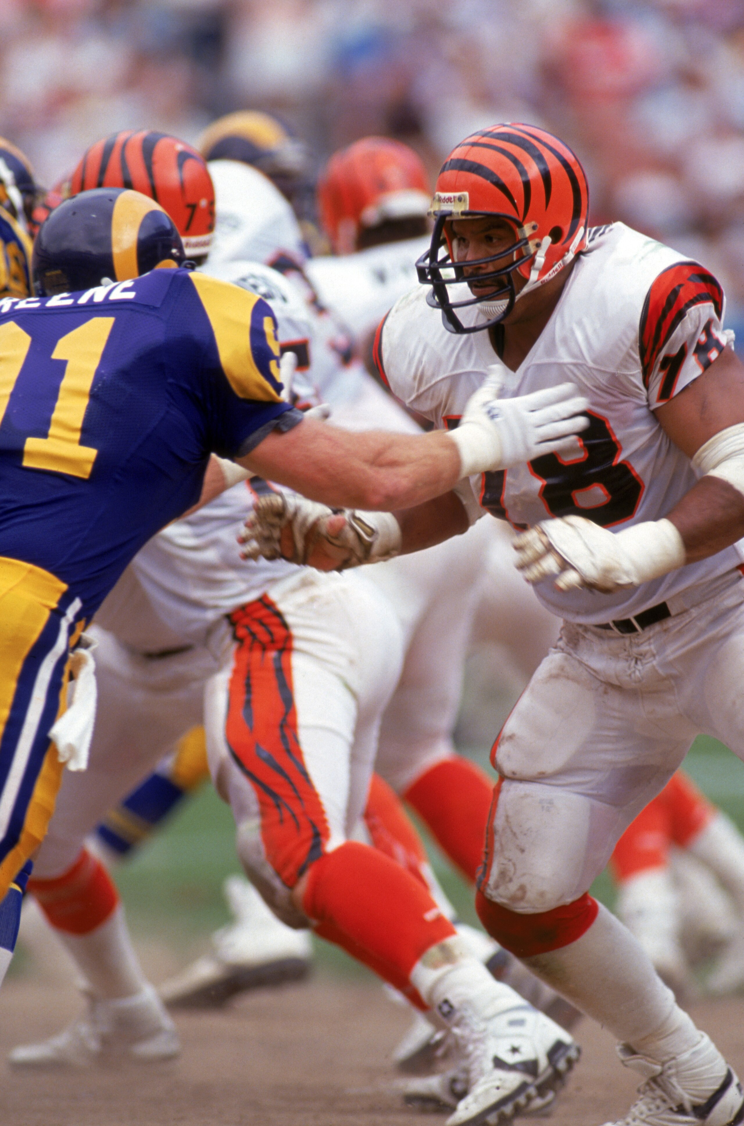 ANAHEIM, CA - OCTOBER 7:  Tackle Anthony Munoz #78 of the Cincinnati Bengals matches up against linebacker Kevin Greene #91 of the Los Angeles Rams during a game at the Anaheim Stadium on October 7, 1990 in Anaheim, California.  Munoz is in his 10th year