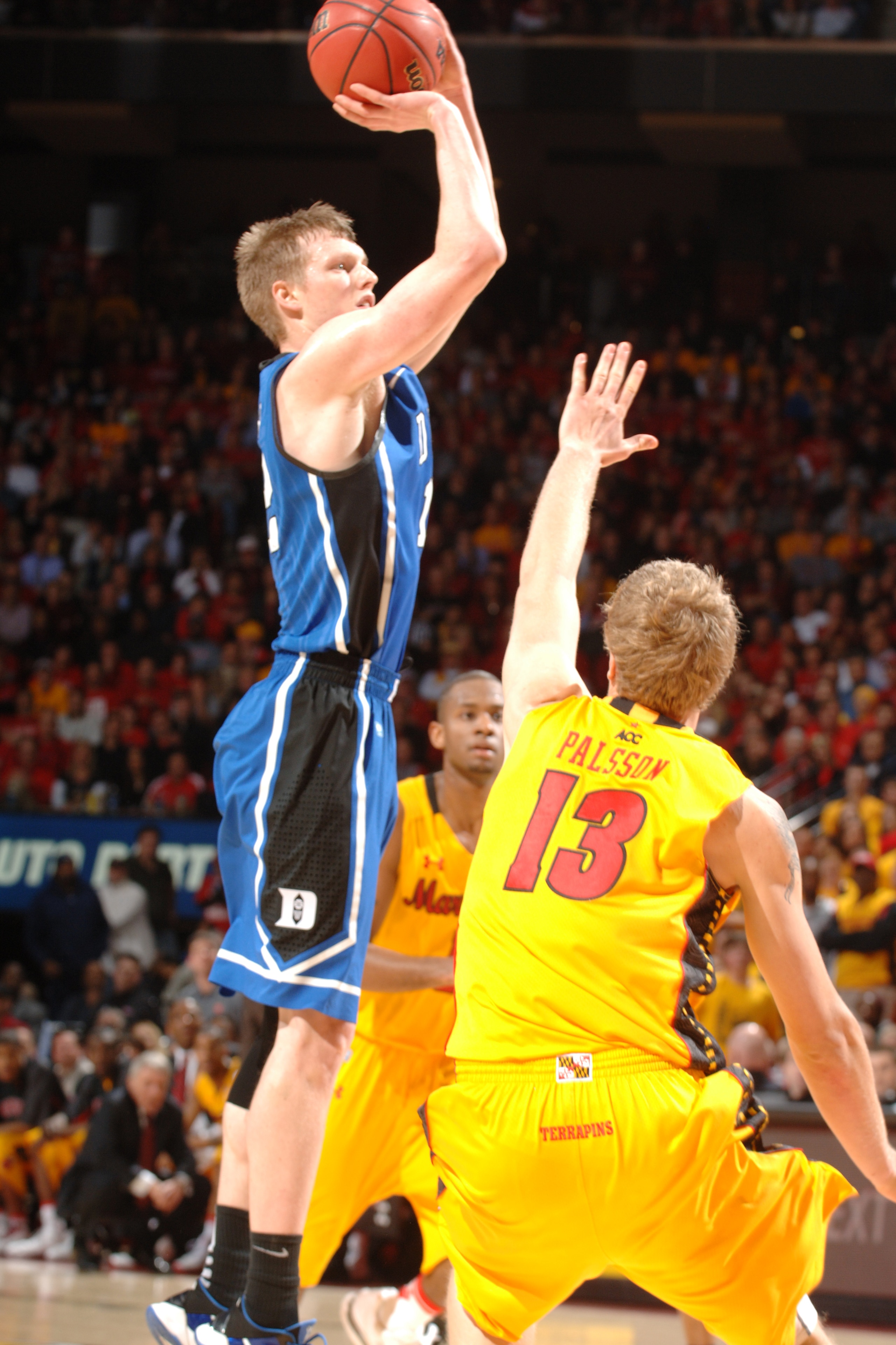 COLLEGE PARK, MD - FEBRUARY 2: Kyle Singler #12 of the Duke Blue Devils takes a jump shot over Haukur Paulsson #13 of the Maryland terrapins during a college basketball game on February 2, 2011 at the Comcast Arena in College Park, Maryland. The Blue Devi