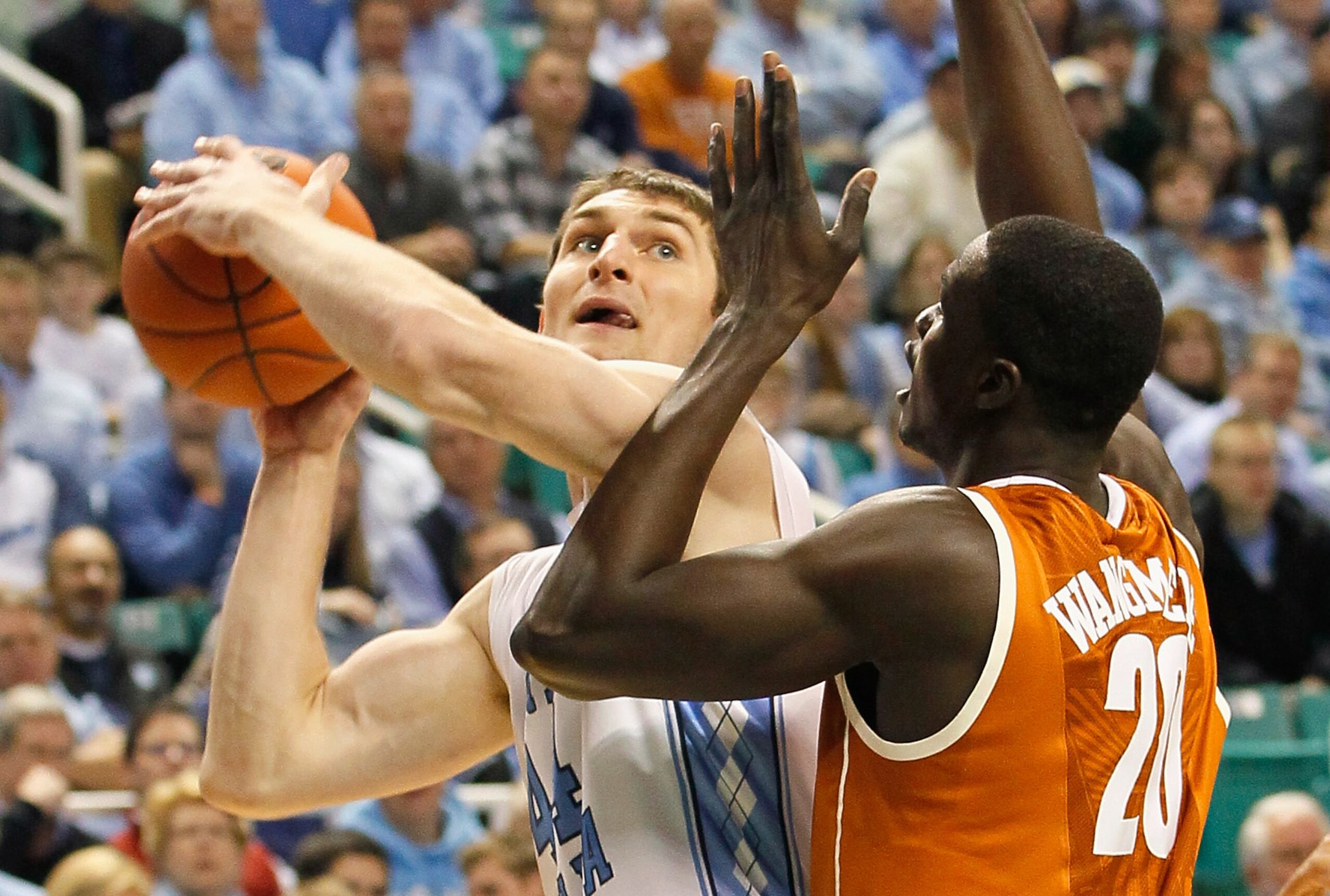 GREENSBORO, NC - DECEMBER 18:  Tyler Zeller #44 of the North Carolina Tar Heels attacks the basket against Alexis Wangmene #20 of the Texas Longhorns at Greensboro Coliseum on December 18, 2010 in Greensboro, North Carolina.  (Photo by Kevin C. Cox/Getty