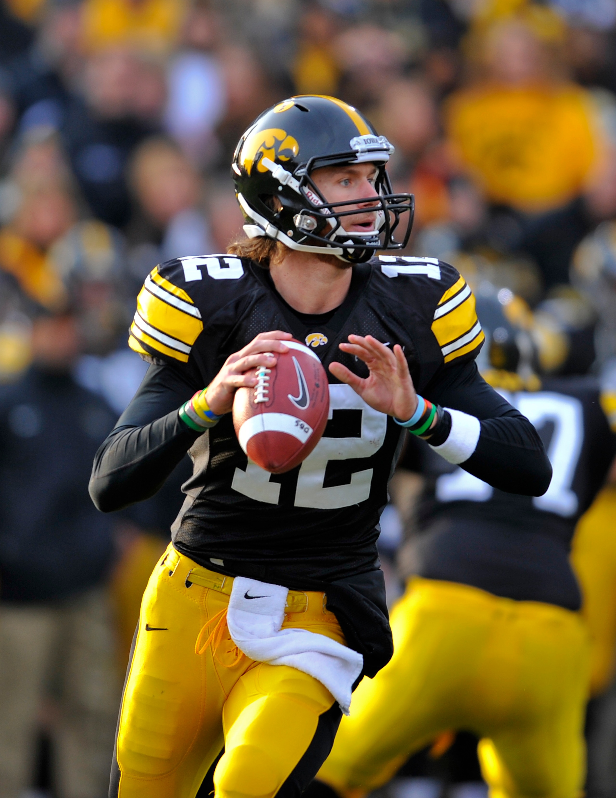 IOWA CITY, IA - NOVEMBER 20:  Quarterback Ricky Stanzi #12 of the University of Iowa Hawkeyes throws under pressure from Ohio State Buckeyes defenders during the first half of play at Kinnick Stadium on November 20, 2010 in Iowa City, Iowa. Ohio State won