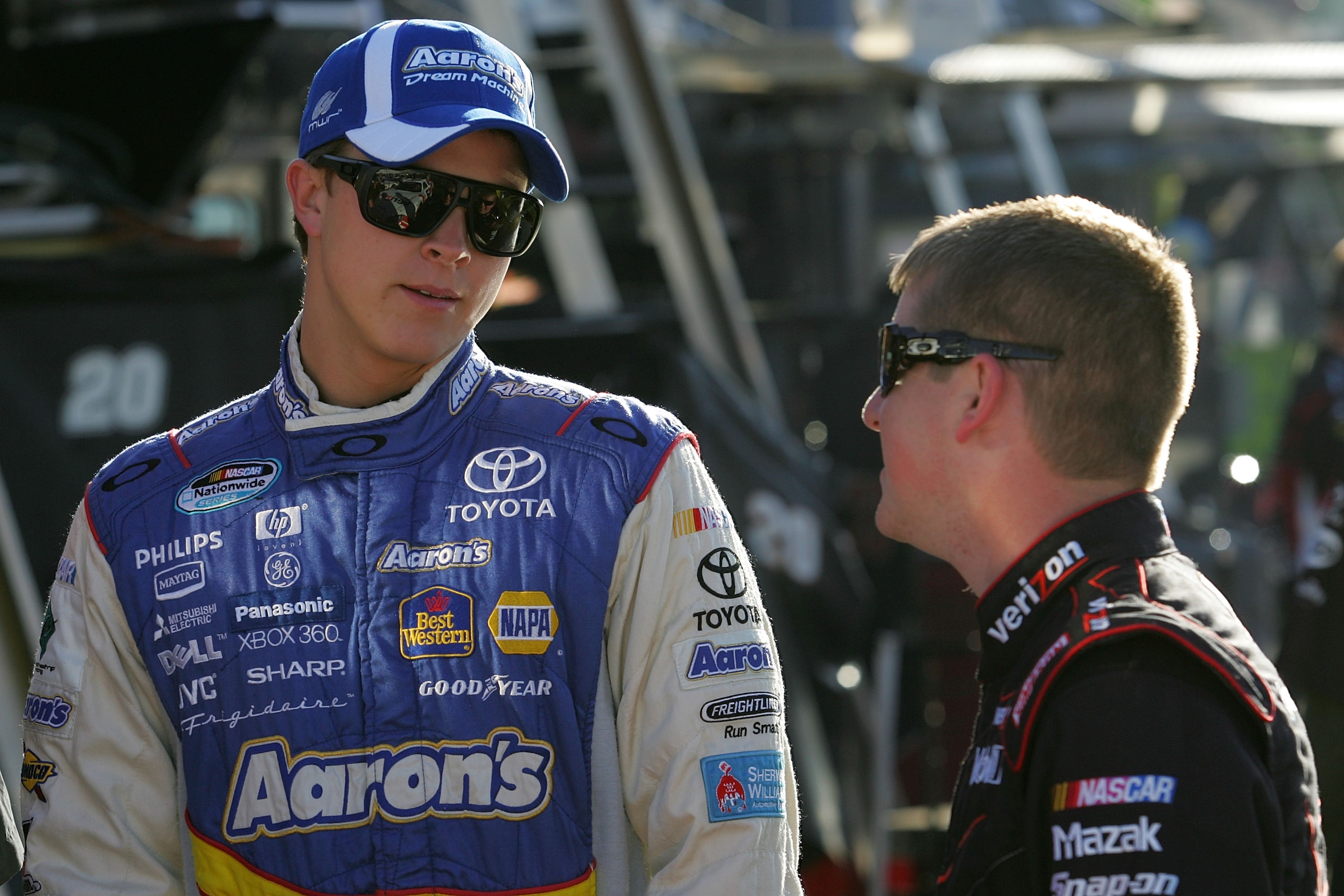 PHOENIX - APRIL 09:  Trevor Bayne, driver of the #99 Aaron's Dream Machine Toyota, talks with Justin Allgaier, driver of the #12 Verizon Wireless Dodge, during practice for the NASCAR Nationwide Series Bashas' Supermarkets 200 at Phoenix International Rac