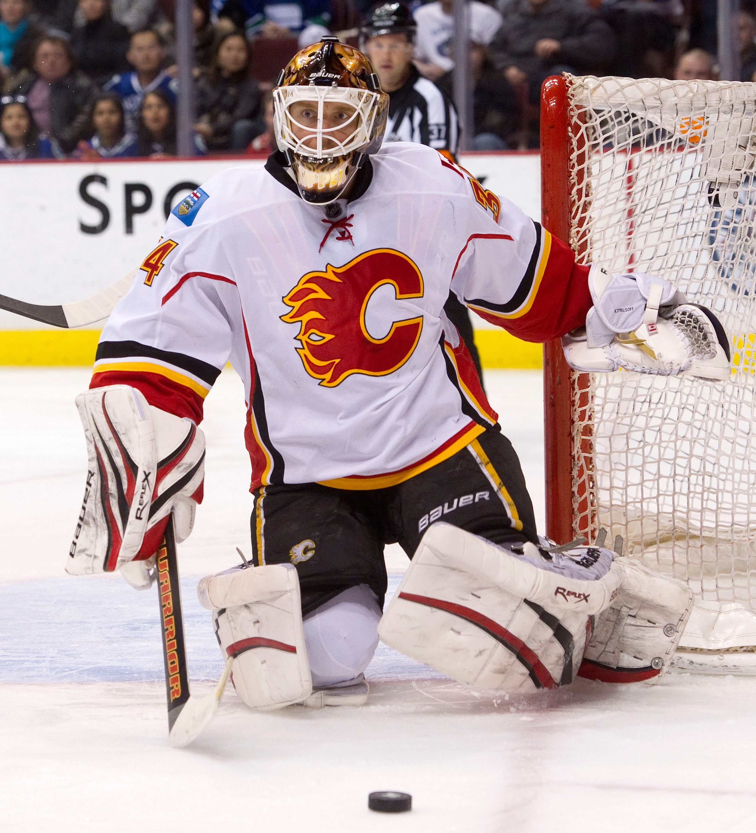 VANCOUVER, CANADA - JANUARY 22: Goalie Miikka Kiprusoff #34 of the Calgary Flames watches the puck roll into the corner after making a save against the Vancouver Canucks during the second period in NHL action on January 22, 2011 at Rogers Arena in Vancouv