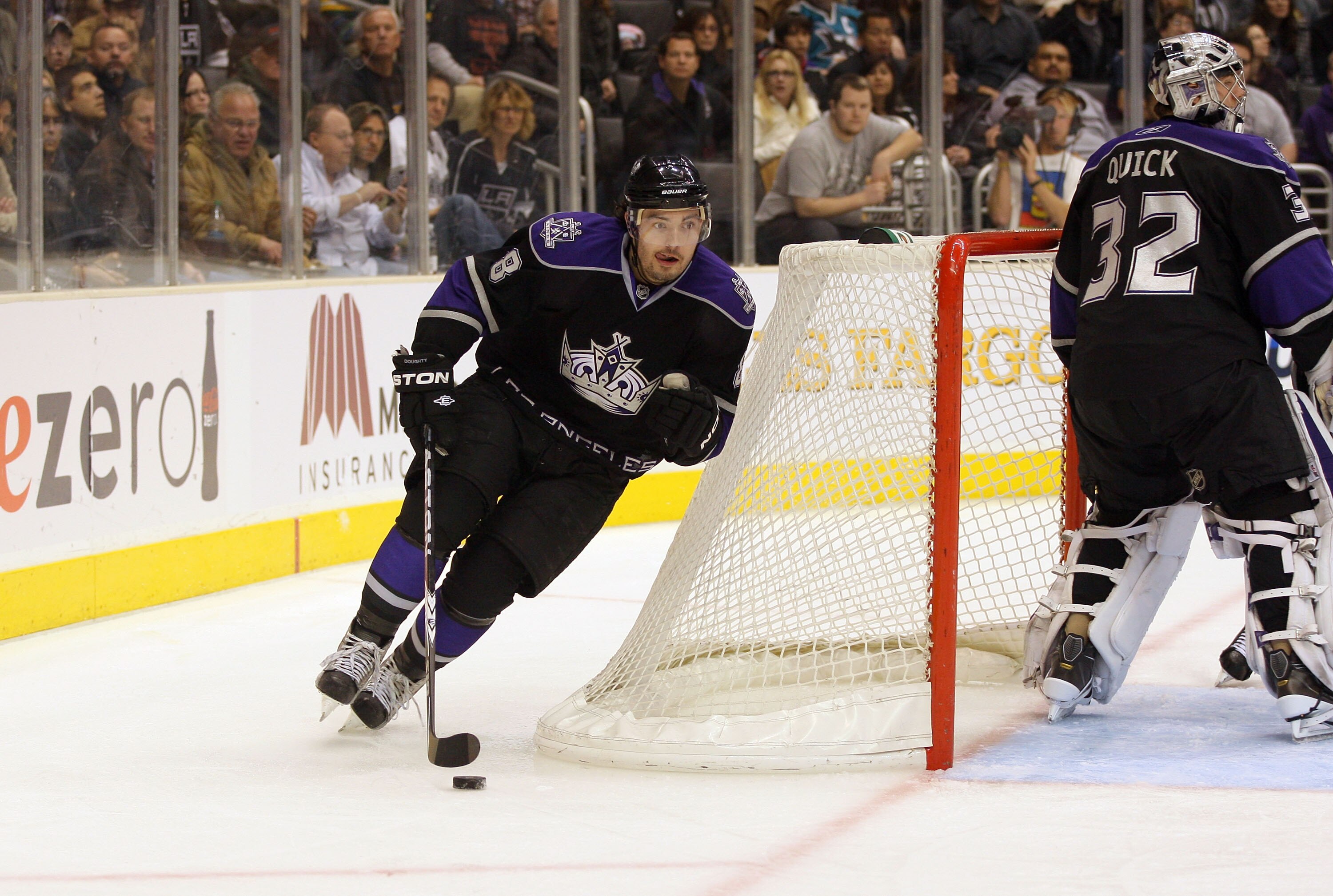 LOS ANGELES, CA - JANUARY 26:  Drew Doughty #8 of the Los Angeles Kings plays the puck around the net so start the breakout play from the Kings zone against the San Jose Sharks during their NHL game at Staples Center on January 26, 2011 in Los Angeles, Ca