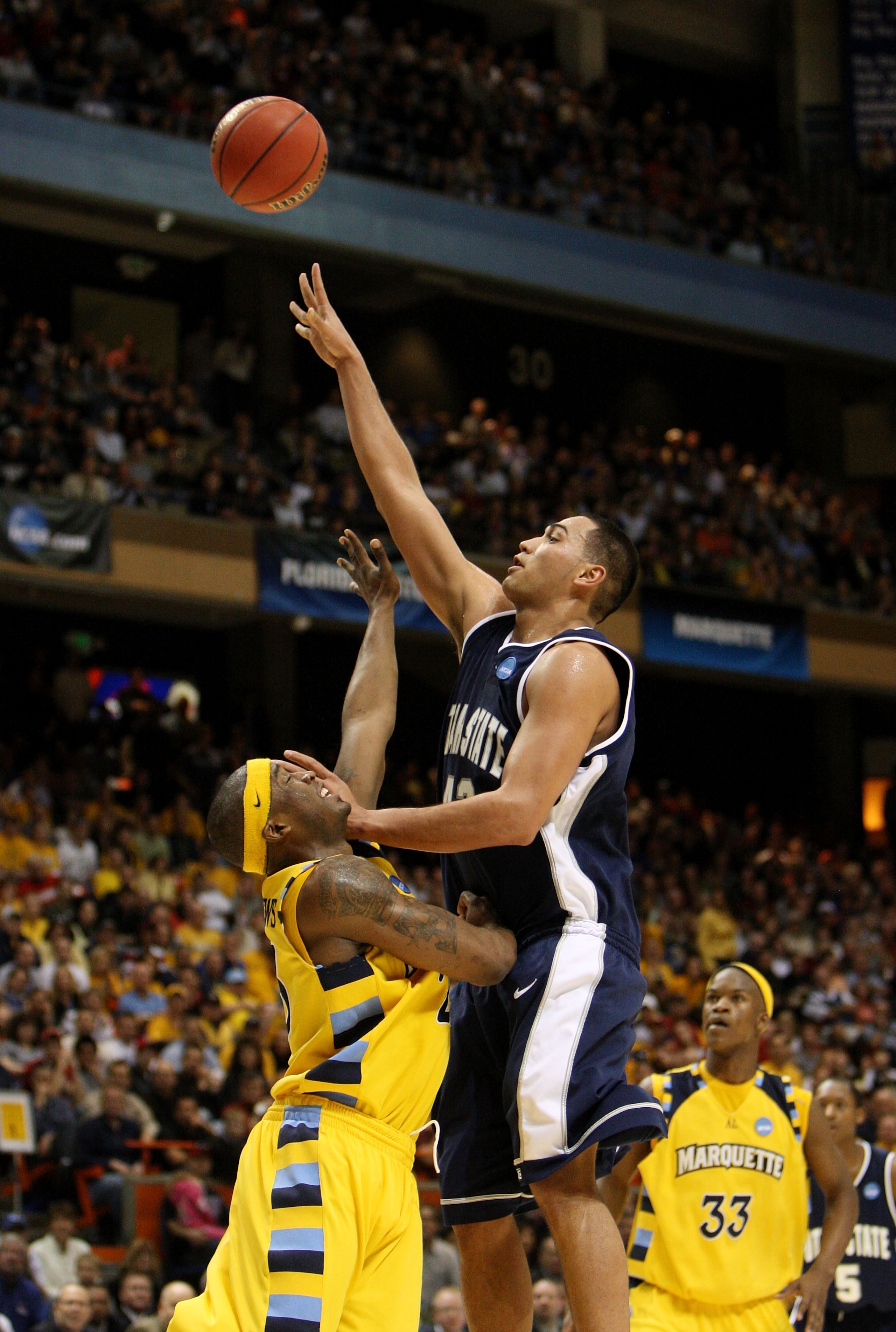 BOISE, ID - MARCH 20:  Forward Tai Wesley #42 of the Utah State Aggies shoots ball against the Marquette Golden Eagles in the first round of the NCAA Division I Men's Basketball Tournament at the Taco Bell Arena on March 20, 2009 in Boise, Idaho.  (Photo
