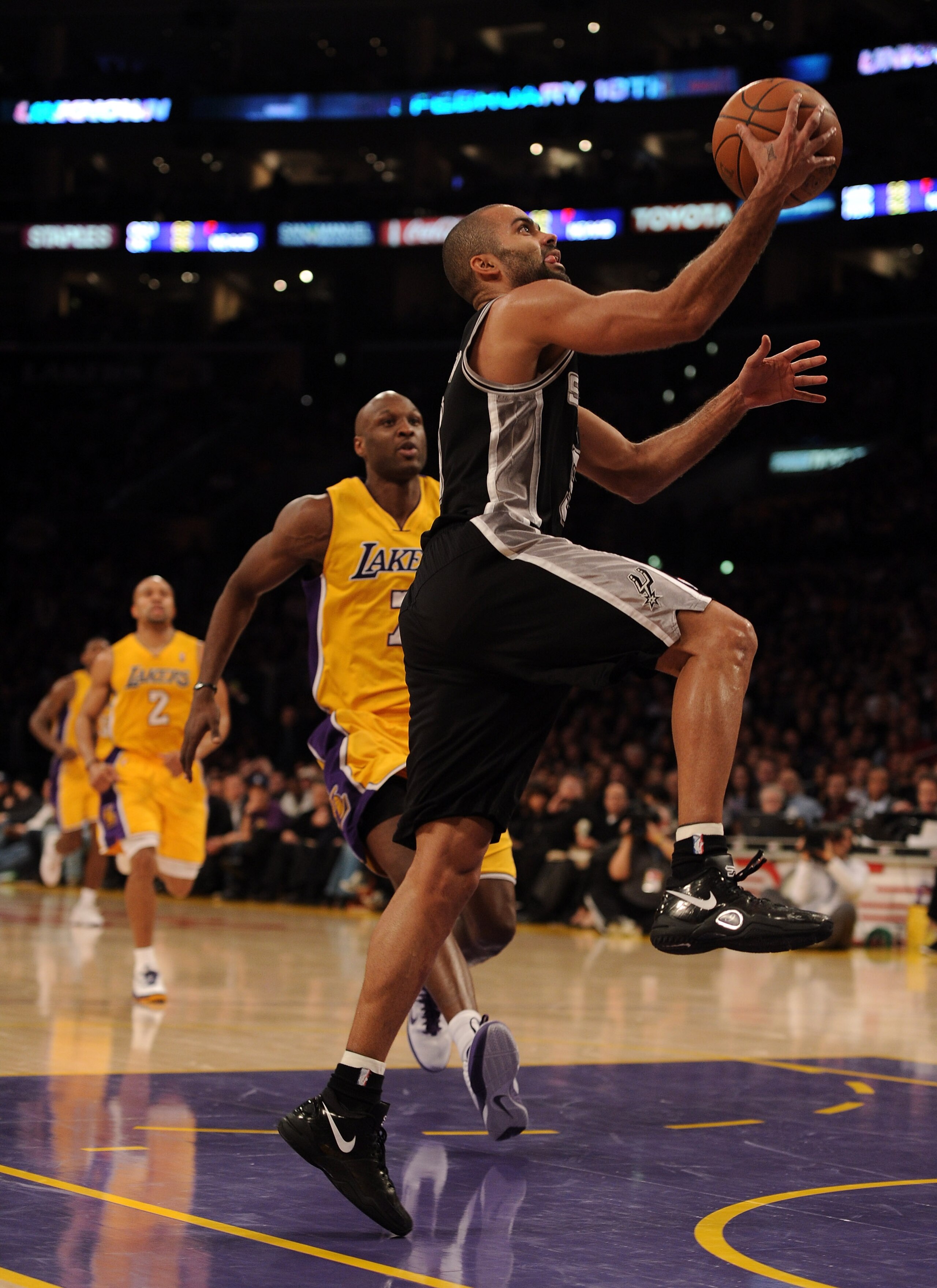 LOS ANGELES, CA - FEBRUARY 03:  Tony Parker #9 of the San Antonio Spurs scores a layup in front of Lamar Odom #7 of the Los Angeles Lakers at Staples Center on February 3, 2011 in Los Angeles, California.  NOTE TO USER: User expressly acknowledges and agr