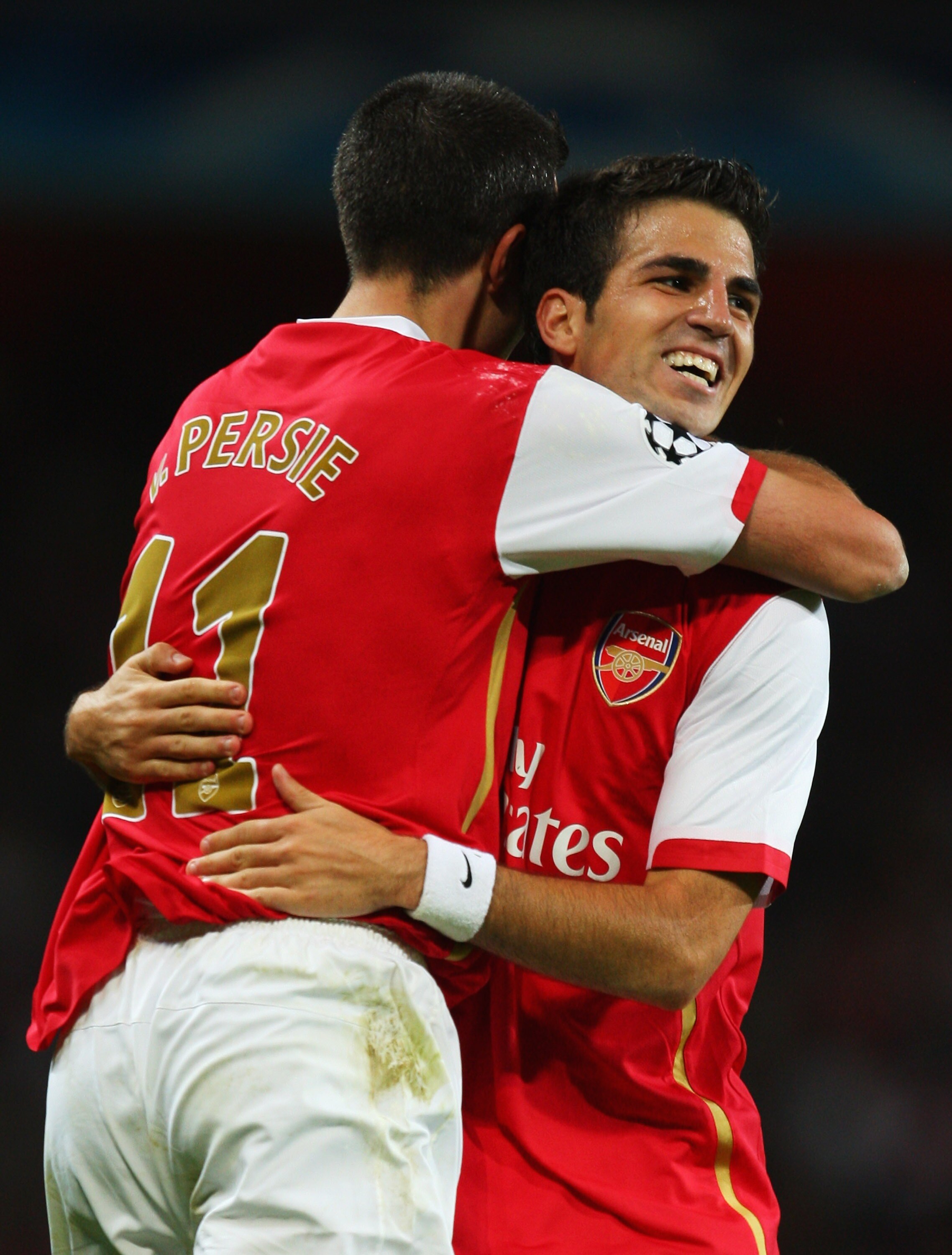 LONDON - SEPTEMBER 19:  Robin van Persie of Arsenal embraces Francesc Fabregas as he scores their second goal during the UEFA Champions League Group H match between Arsenal and Sevilla at the Emirates Stadium on September 19, 2007 in London, England.  (Ph