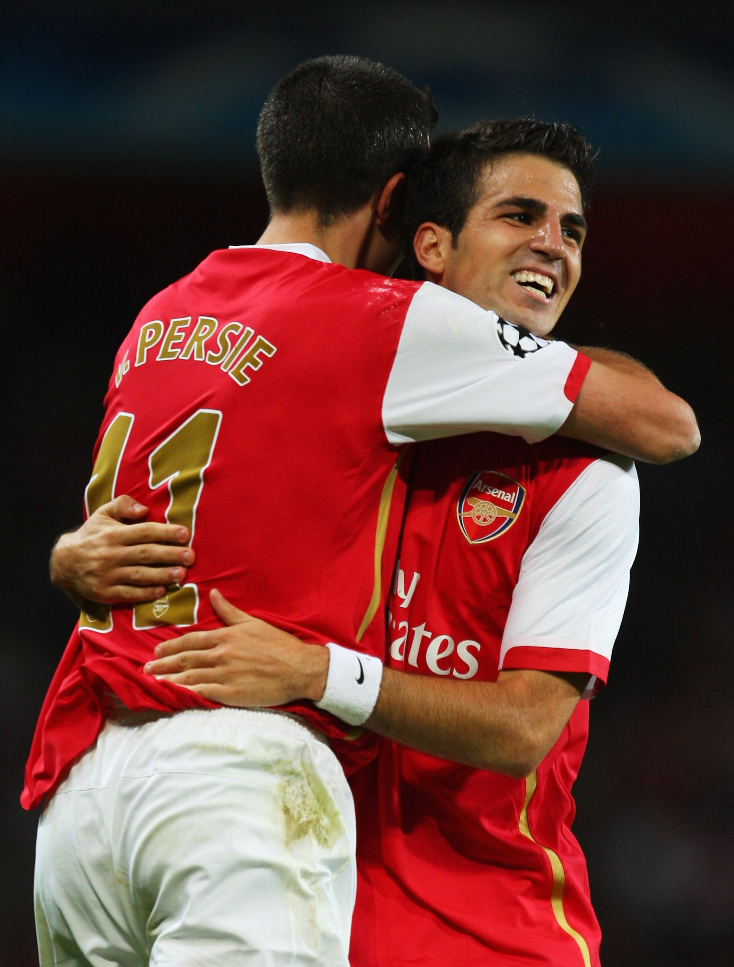 LONDON - SEPTEMBER 19:  Robin van Persie of Arsenal embraces Francesc Fabregas as he scores their second goal during the UEFA Champions League Group H match between Arsenal and Sevilla at the Emirates Stadium on September 19, 2007 in London, England.  (Ph