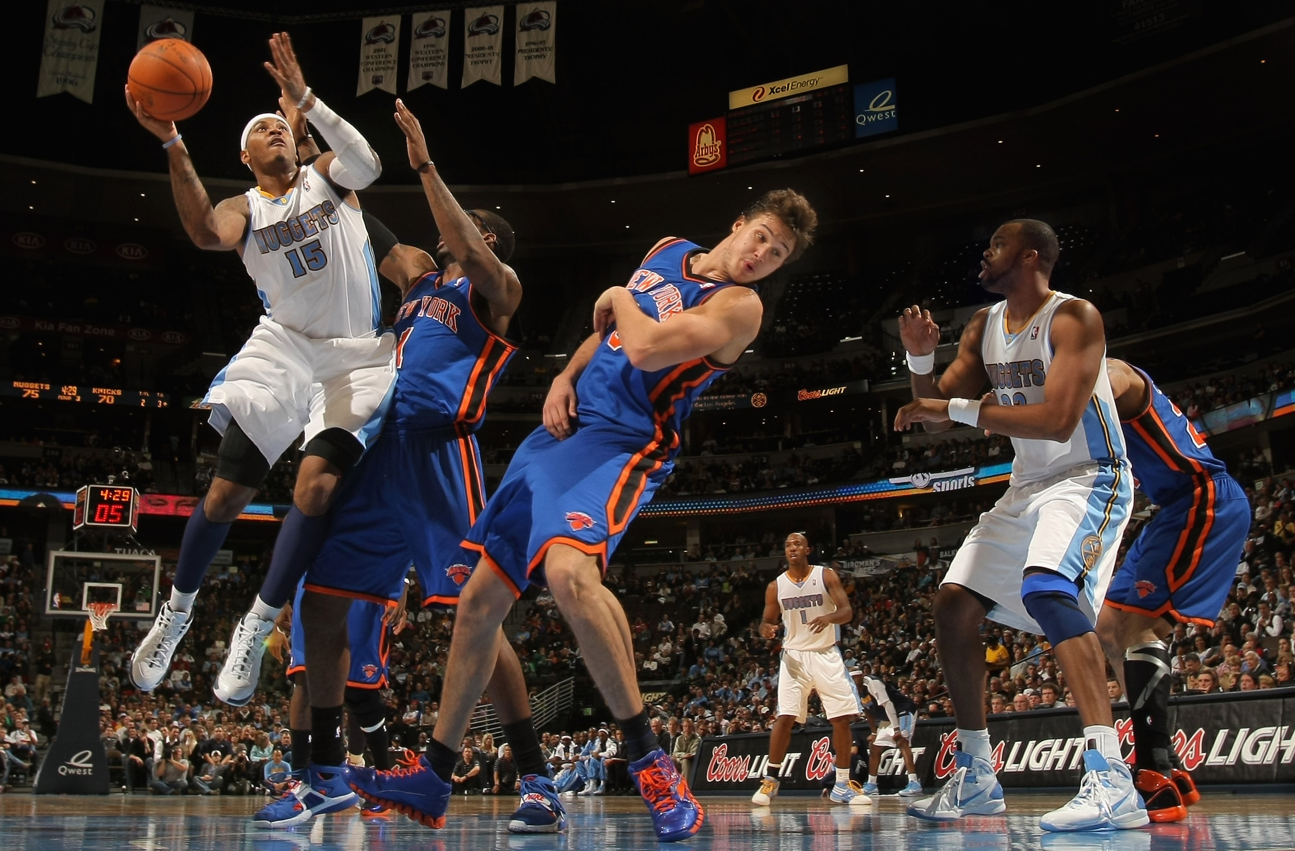 DENVER - NOVEMBER 16: Carmelo Anthony #15 of the Denver Nuggets puts up a shot over Amar'e Stoudemire #1 and Danilo Gallinari #8 of the New York Knicks at the Pepsi Center on November 16, 2010 in Denver, Colorado. The Nuggets defeated the Knicks 120-118. DENVER - NOVEMBER 16: Carmelo Anthony #15 of the Denver Nuggets puts up a shot over Amar'e Stoudemire #1 and Danilo Gallinari #8 of the New York Knicks at the Pepsi Center on November 16, 2010 in Denver, Colorado. The Nuggets defeated the Knicks 120-118.