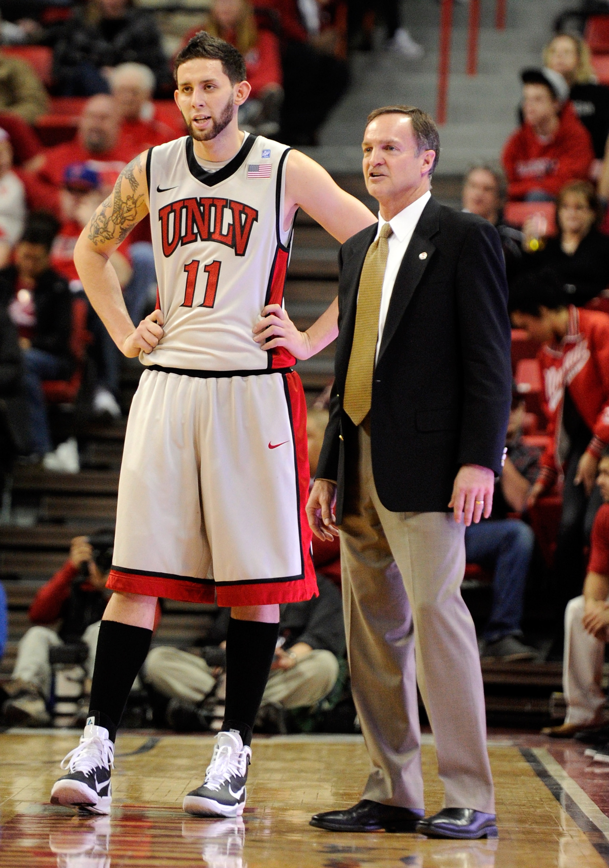 LAS VEGAS, NV - FEBRUARY 02:  Carlos Lopez #11 of the UNLV Rebels talks to his head coach Lon Kruger during their game against the Utah Utes at the Thomas & Mack Center February 2, 2011 in Las Vegas, Nevada. UNLV won 67-54.  (Photo by Ethan Miller/Getty I