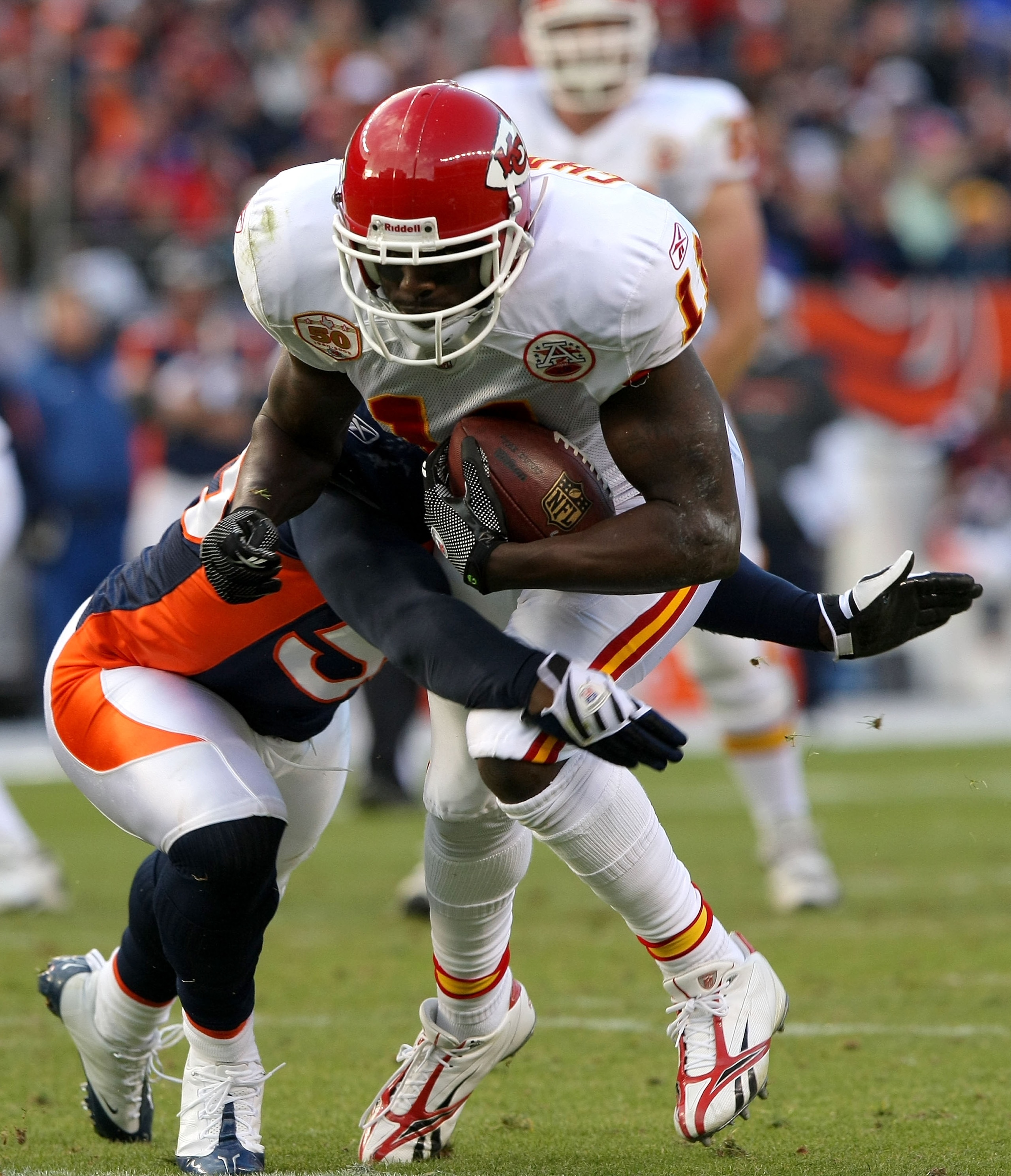 DENVER - JANUARY 03: Chris Chambers #11 of the Kansas City Chiefs makes a first down reception to the two yard line as D.J. Williams #55 of the Denver Broncos makes the tackle during NFL action at Invesco Field at Mile High on January 3, 2010 in Denver, C DENVER - JANUARY 03: Chris Chambers #11 of the Kansas City Chiefs makes a first down reception to the two yard line as D.J. Williams #55 of the Denver Broncos makes the tackle during NFL action at Invesco Field at Mile High on January 3, 2010 in Denver, C