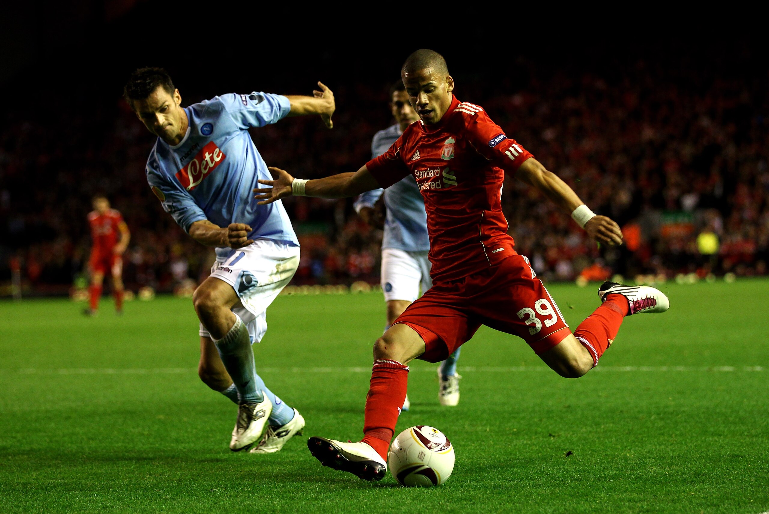 LIVERPOOL, ENGLAND - NOVEMBER 04:  Nathan Eccleston of Liverpool crosses the ball under pressure from Christian Maggio of Napoli during the UEFA Europa League Group K match beteween Liverpool and SSC Napoli at Anfield on November 4, 2010 in Liverpool, Eng