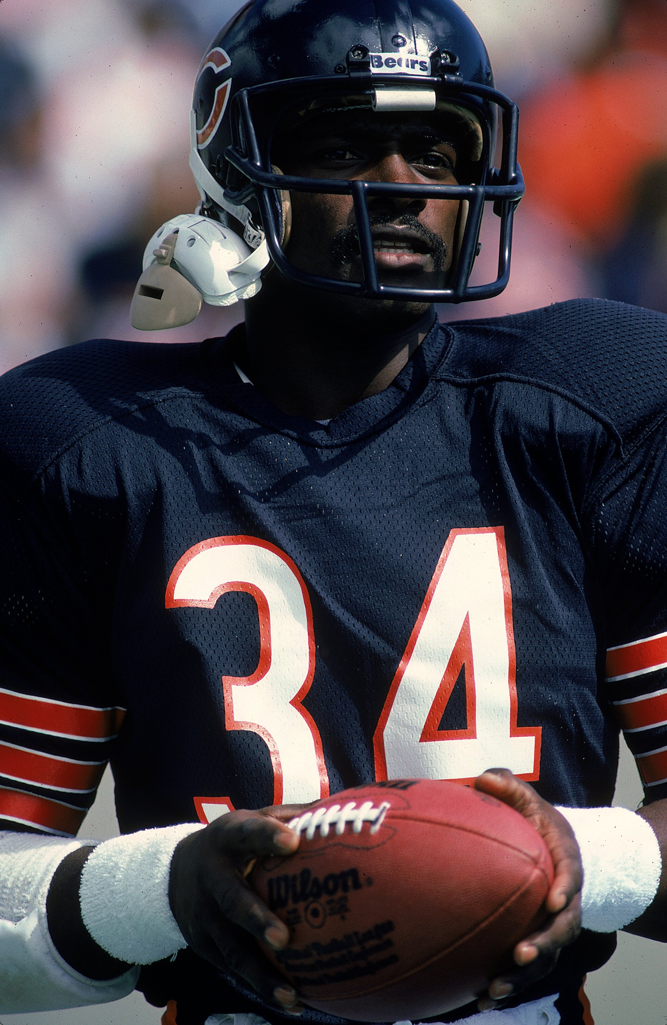 Walter Payton #34 of the Chicago Bears holds the ball during a game.
