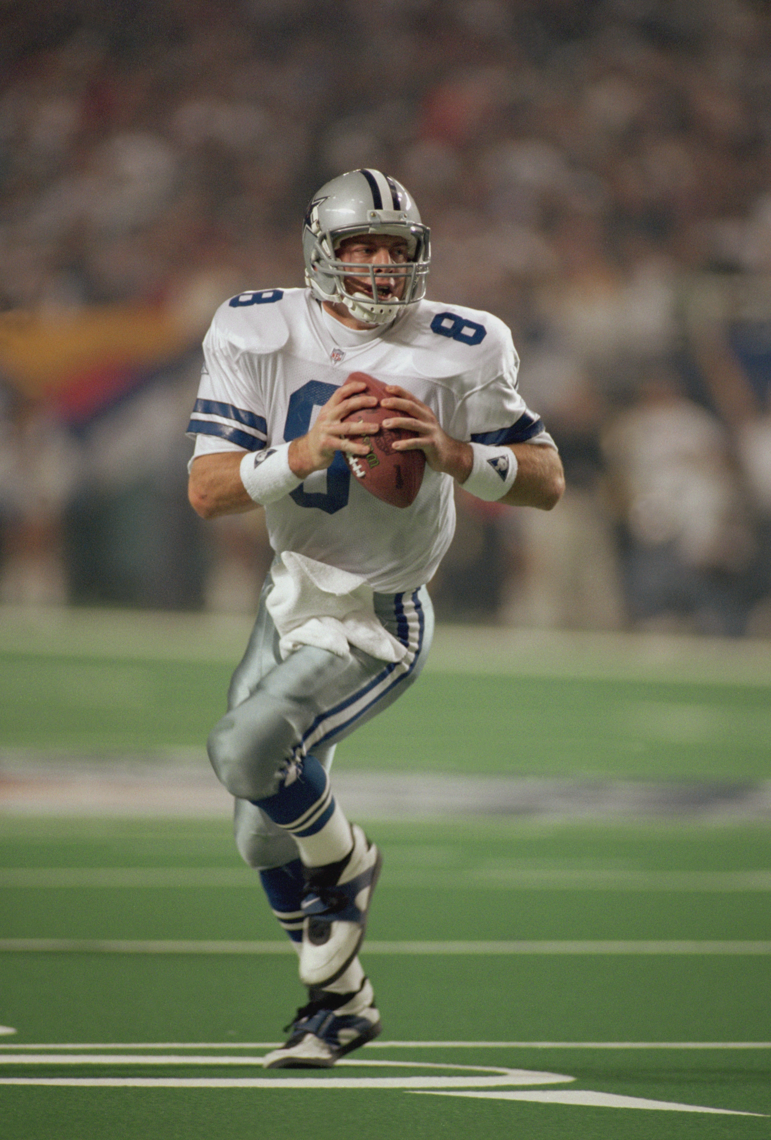 ATLANTA, GA - JANUARY 30:  Quarterback Troy Aikman #8 of the Dallas Cowboys rolls out to his right during Super Bowl XXVIII on January 30, 1994 against the Buffalo Bills at the Georgia Dome in Atlanta, Georgia.  The Cowboys defeated the Bills 30-13.  (Pho