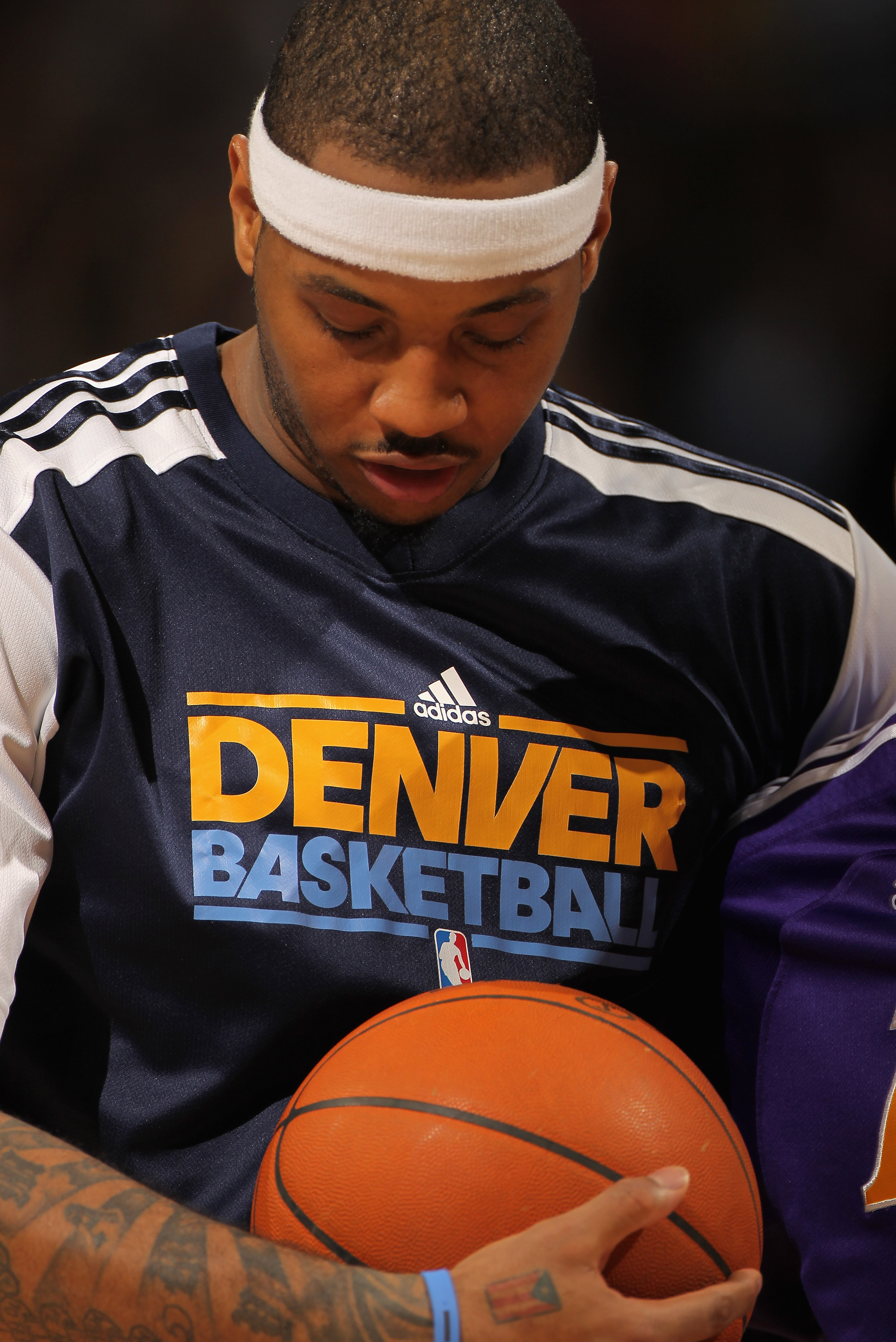 DENVER, CO - JANUARY 21:  Carmelo Anthony #15 of the Denver Nuggets looks on as he warms up for the second half against the Los Angeles Lakers at the Pepsi Center on January 21, 2011 in Denver, Colorado. The Lakers defeated the Nuggets 107-97. NOTE TO USE