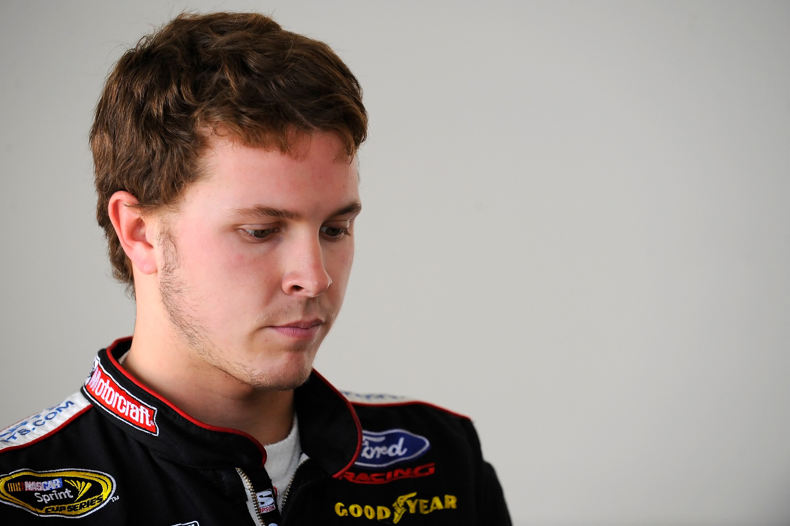 DAYTONA BEACH, FL - JANUARY 22:  Trevor Bayne, driver of the #21 Woods Brothers Racing Ford, waits in the garage for testing at Daytona International Speedway on January 22, 2011 in Daytona Beach, Florida.  (Photo by Jared C. Tilton/Getty Images for NASCA