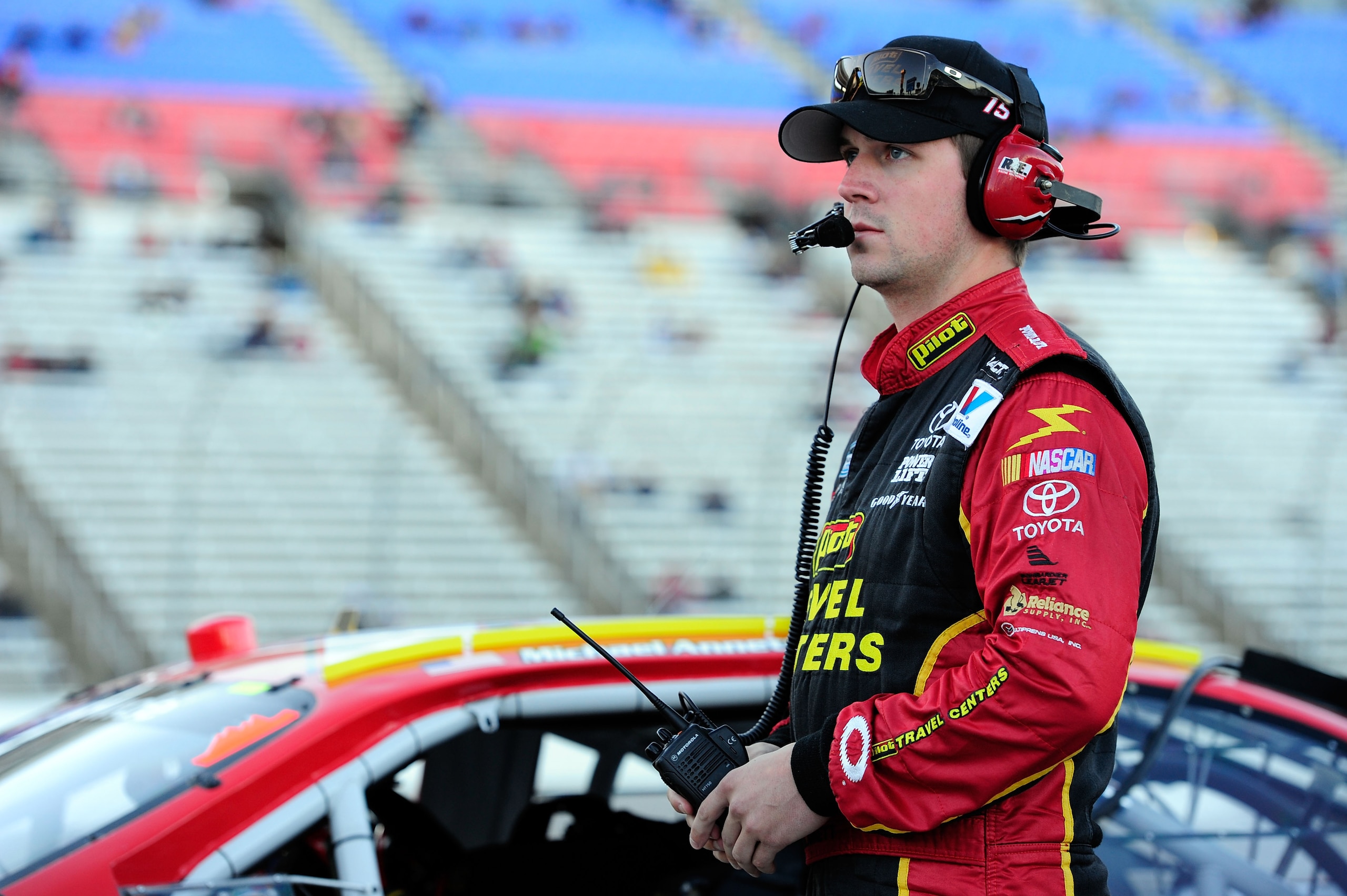 FORT WORTH, TX - NOVEMBER 05:  Michael Annett, driver of the #15 Pilot Flying J Coffee Toyota, stands on the grid during qualifying for the NASCAR Nationwide Series O'Reilly Auto Parts Challenge at Texas Motor Speedway on November 5, 2010 in Fort Worth, T