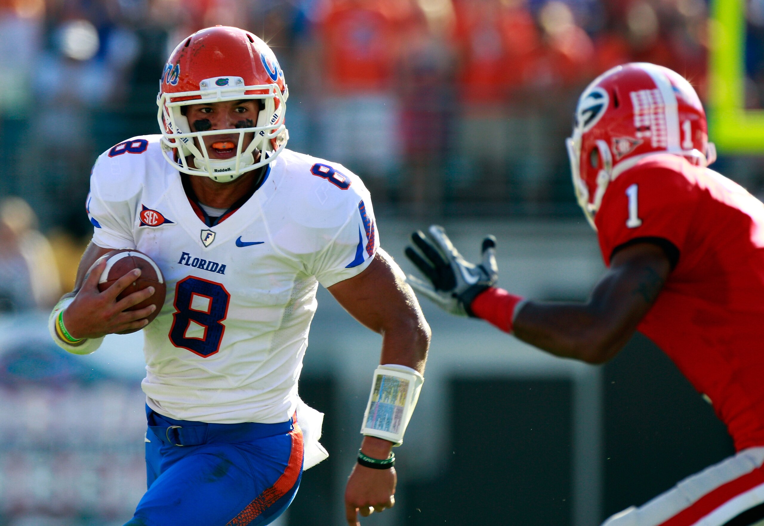 JACKSONVILLE, FL - OCTOBER 30:  Quarterback Trey Burton #8 of the Florida Gators attempts to run past Branden Smith #1 of the Georgia Bulldogs during the game at EverBank Field on October 30, 2010 in Jacksonville, Florida.  (Photo by Sam Greenwood/Getty I
