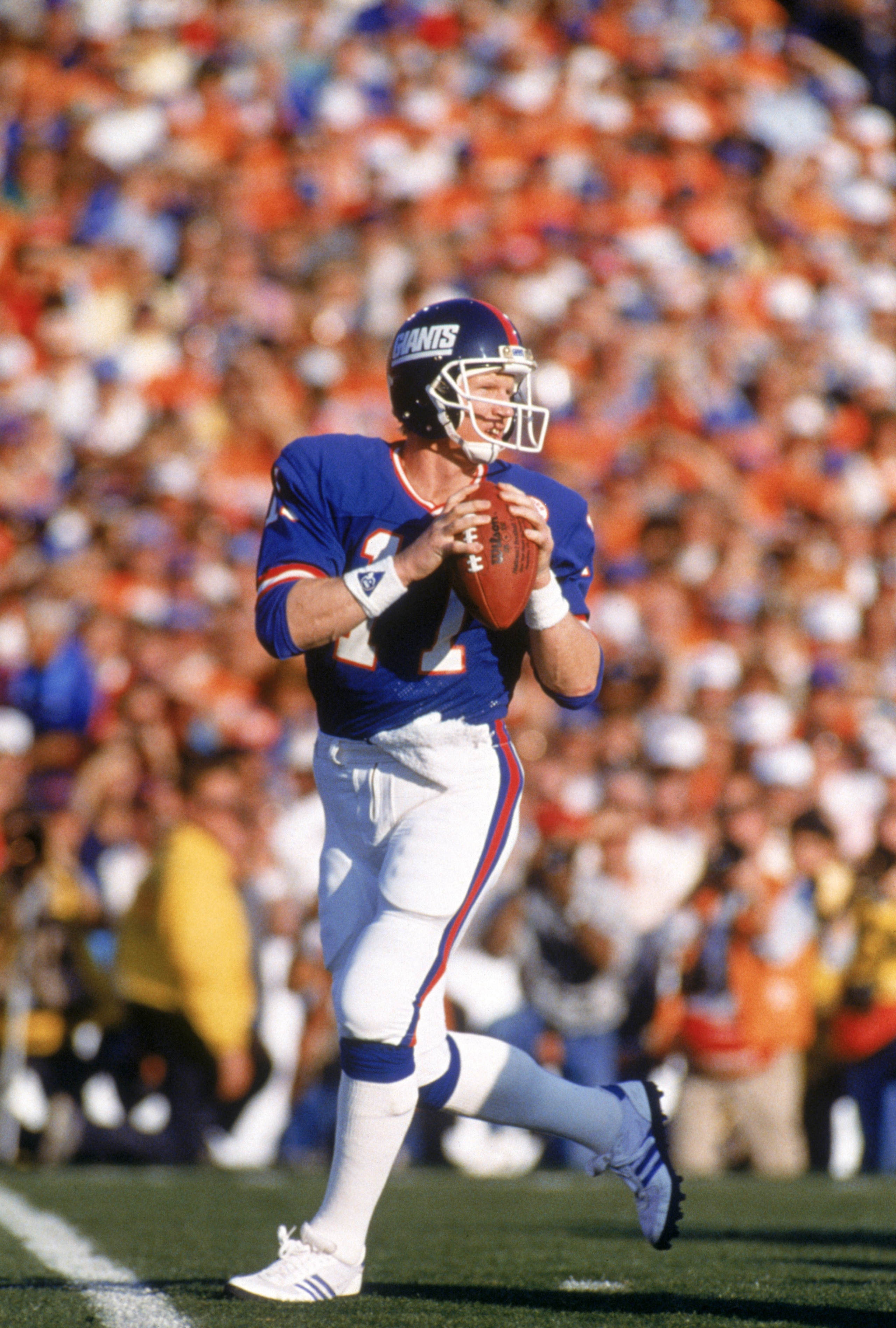 PASADENA, CA - JANUARY 25:  Quarterback Phil Simms #11 of the New York Giants drops back to pass against the Denver Broncos during Super Bowl XXI at the Rose Bowl on January 25, 1987 in Pasadena, California. The Giants defeated the Broncos 39-20. (Photo b