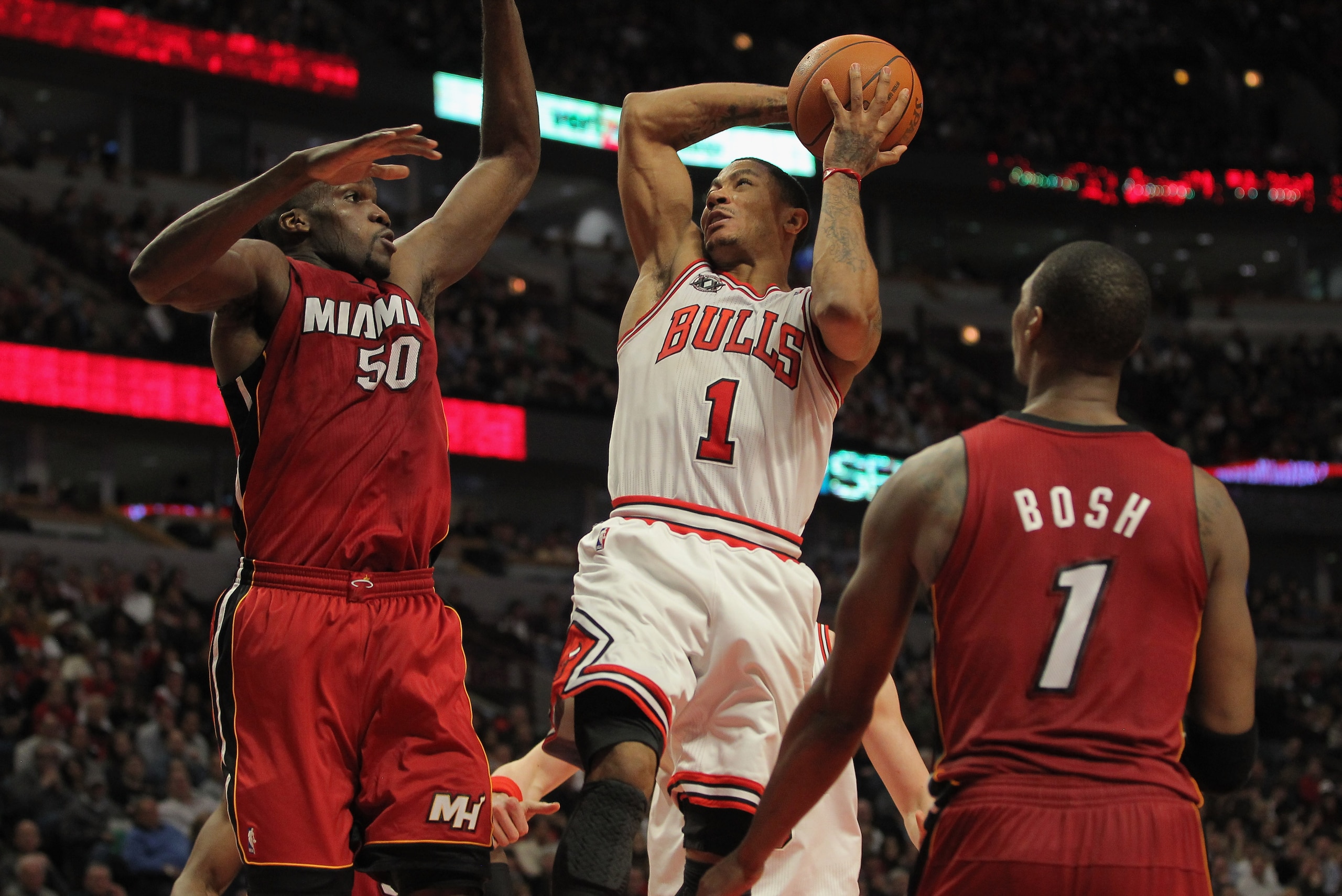 CHICAGO, IL - JANUARY 15: Derrick Rose #1 of the Chicago Bulls gets off a shot as he is fouled by Joel Anthony #50 of the Miami Heat while Chris Bosh #1 of the Heat follows the action at the United Center on January 15, 2011 in Chicago, Illinois. NOTE TO CHICAGO, IL - JANUARY 15: Derrick Rose #1 of the Chicago Bulls gets off a shot as he is fouled by Joel Anthony #50 of the Miami Heat while Chris Bosh #1 of the Heat follows the action at the United Center on January 15, 2011 in Chicago, Illinois. NOTE TO