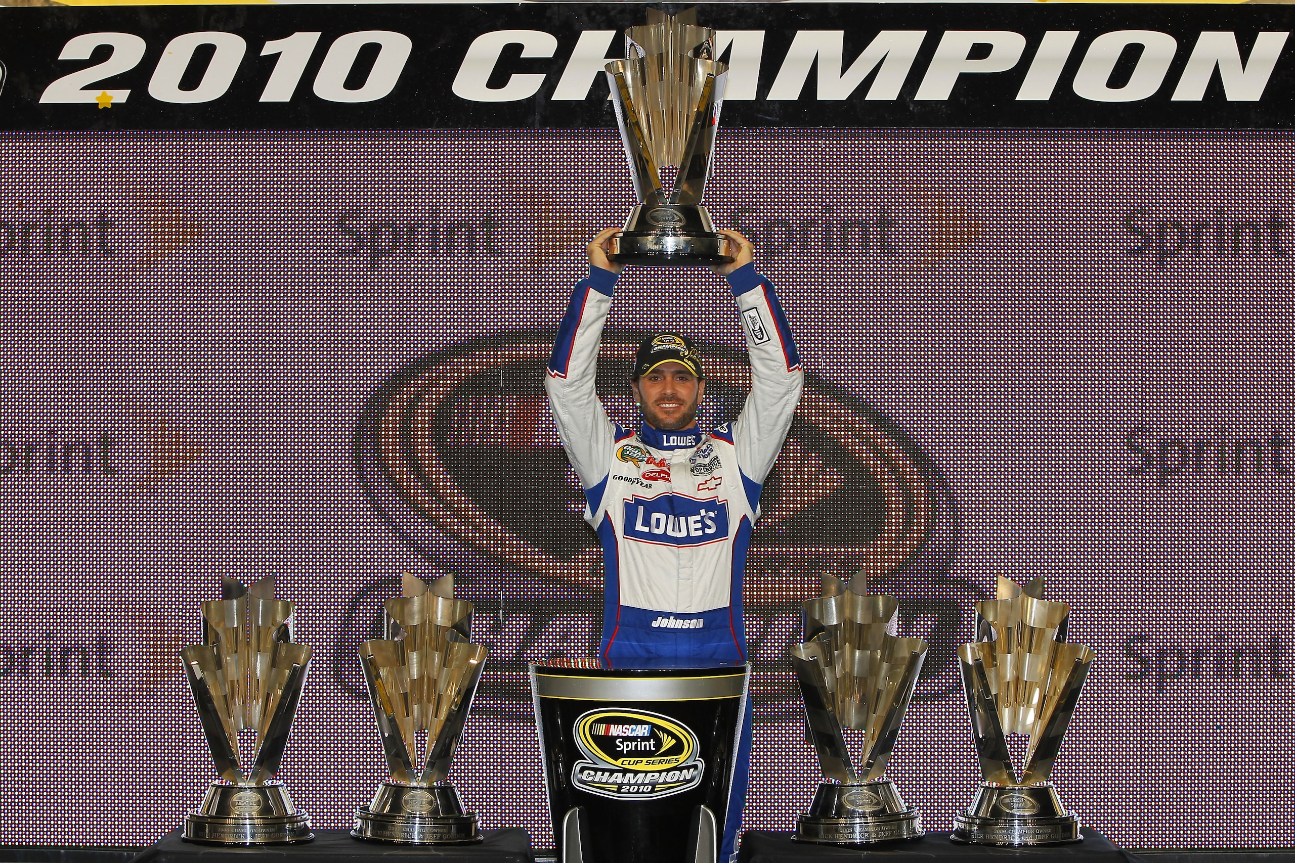 HOMESTEAD, FL - NOVEMBER 21:  Jimmie Johnson, driver of the #48 Lowe's Chevrolet, celebrates after finishing in second place in the Ford 400 to clinch his fifth consecutive NASCAR Sprint Cup championship at Homestead-Miami Speedway on November 21, 2010 in