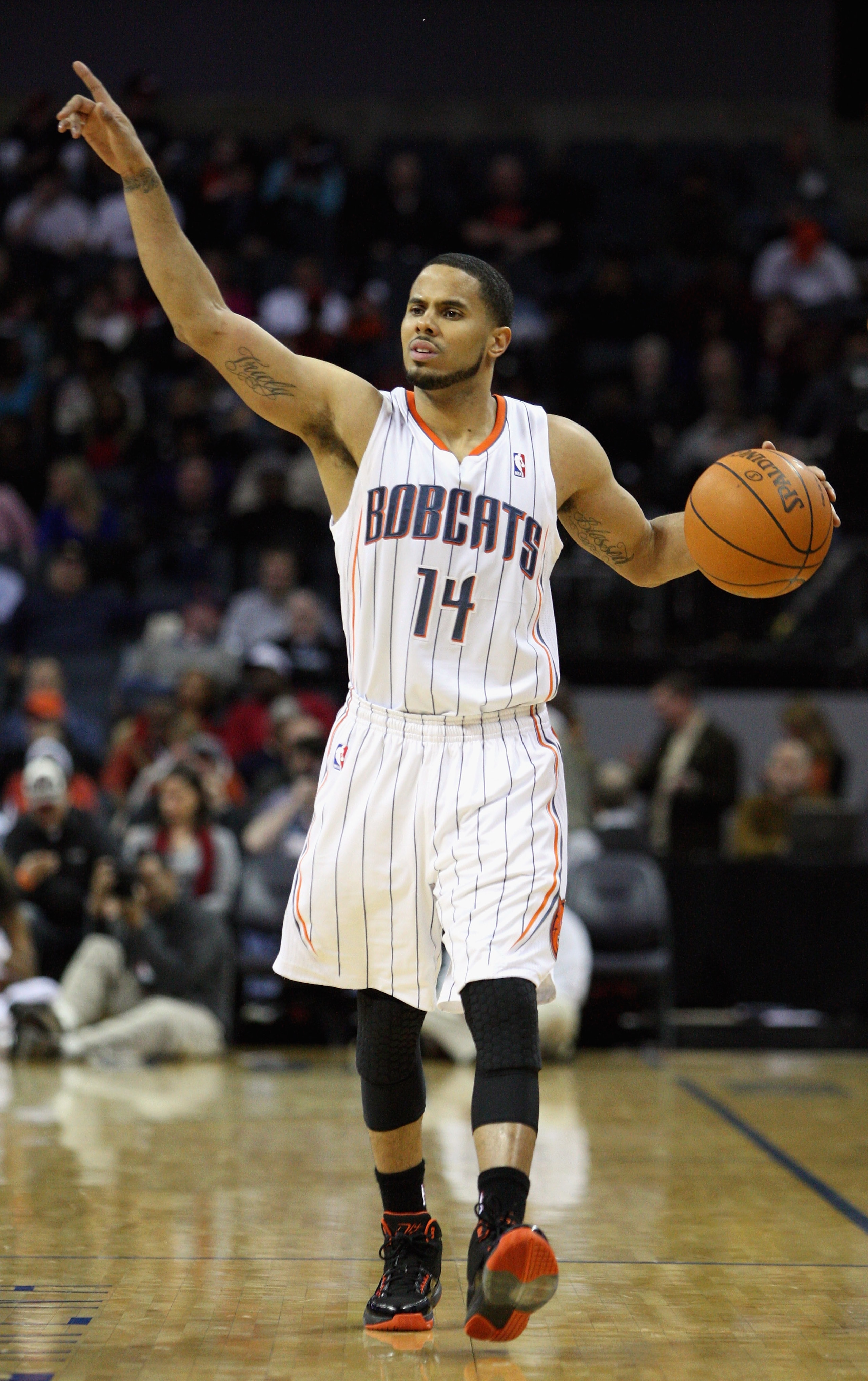 CHARLOTTE, NC - JANUARY 12: D.J. Augustin #14 of the Charlotte Bobcats calls a play against the Chicago Bulls during their game at Time Warner Cable Arena on January 12, 2011 in Charlotte, North Carolina. NOTE TO USER: User expressly acknowledges and agr CHARLOTTE, NC - JANUARY 12: D.J. Augustin #14 of the Charlotte Bobcats calls a play against the Chicago Bulls during their game at Time Warner Cable Arena on January 12, 2011 in Charlotte, North Carolina. NOTE TO USER: User expressly acknowledges and agr