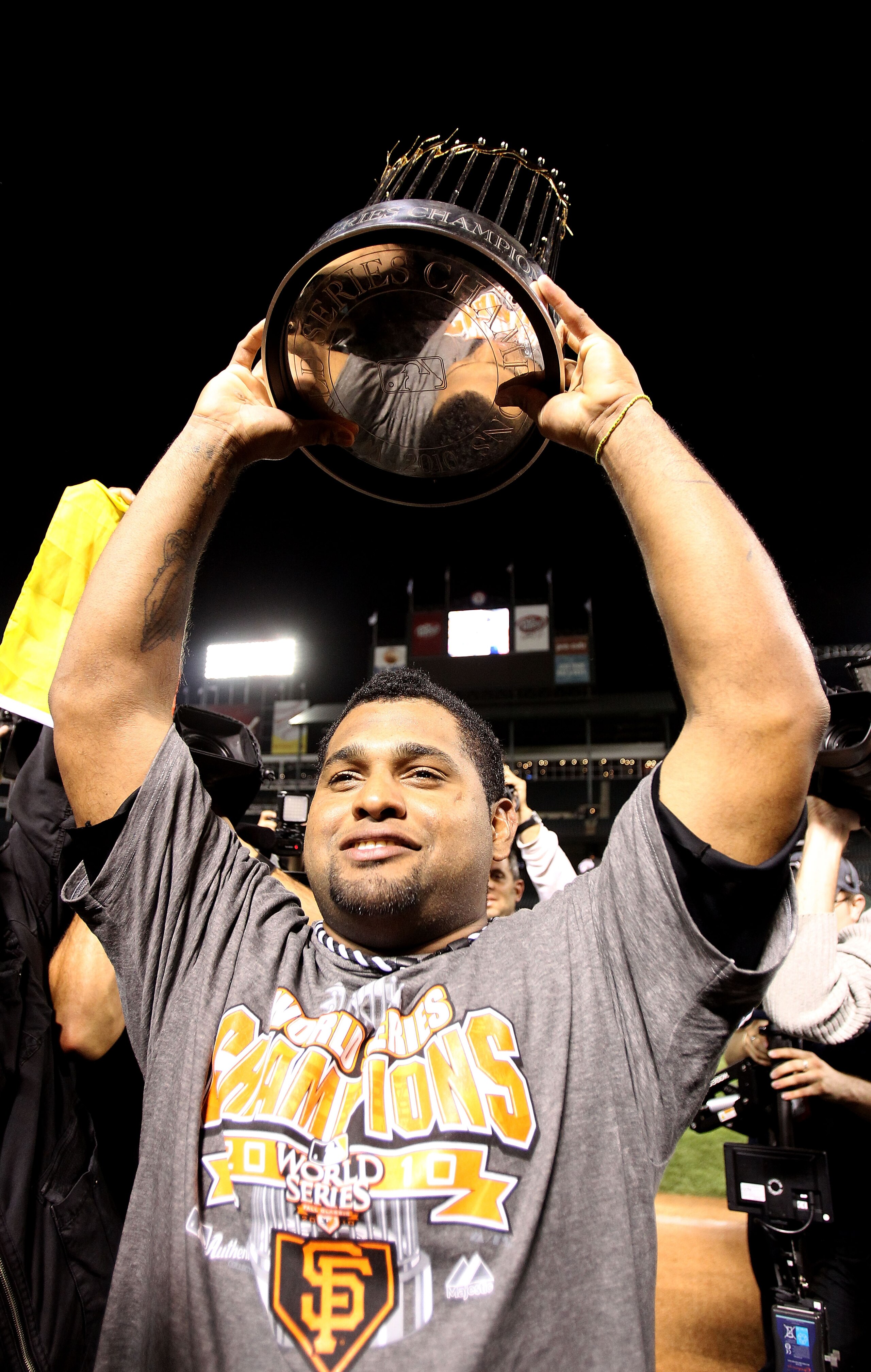ARLINGTON, TX - NOVEMBER 01:  Pablo Sandovalof the San Francisco Giants celebrates with the World Series Championship trophy after the Giants won 3-1 the Texas Rangers in Game Five of the 2010 MLB World Series at Rangers Ballpark in Arlington on November