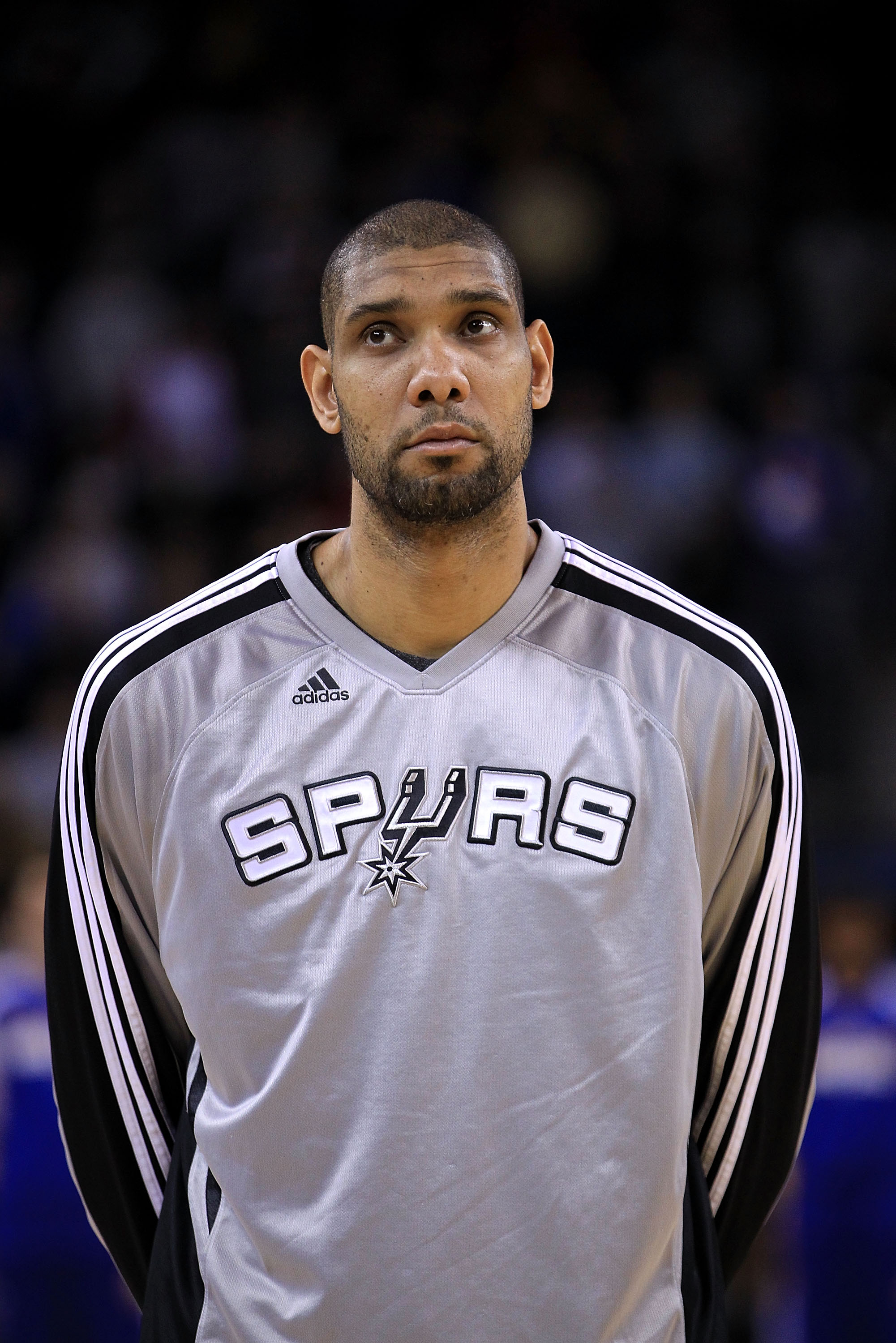 OAKLAND, CA - JANUARY 24:  Tim Duncan #21 of the San Antonio Spurs stands for the National Anthem before their game against the Golden State Warriors at Oracle Arena on January 24, 2011 in Oakland, California.  NOTE TO USER: User expressly acknowledges an