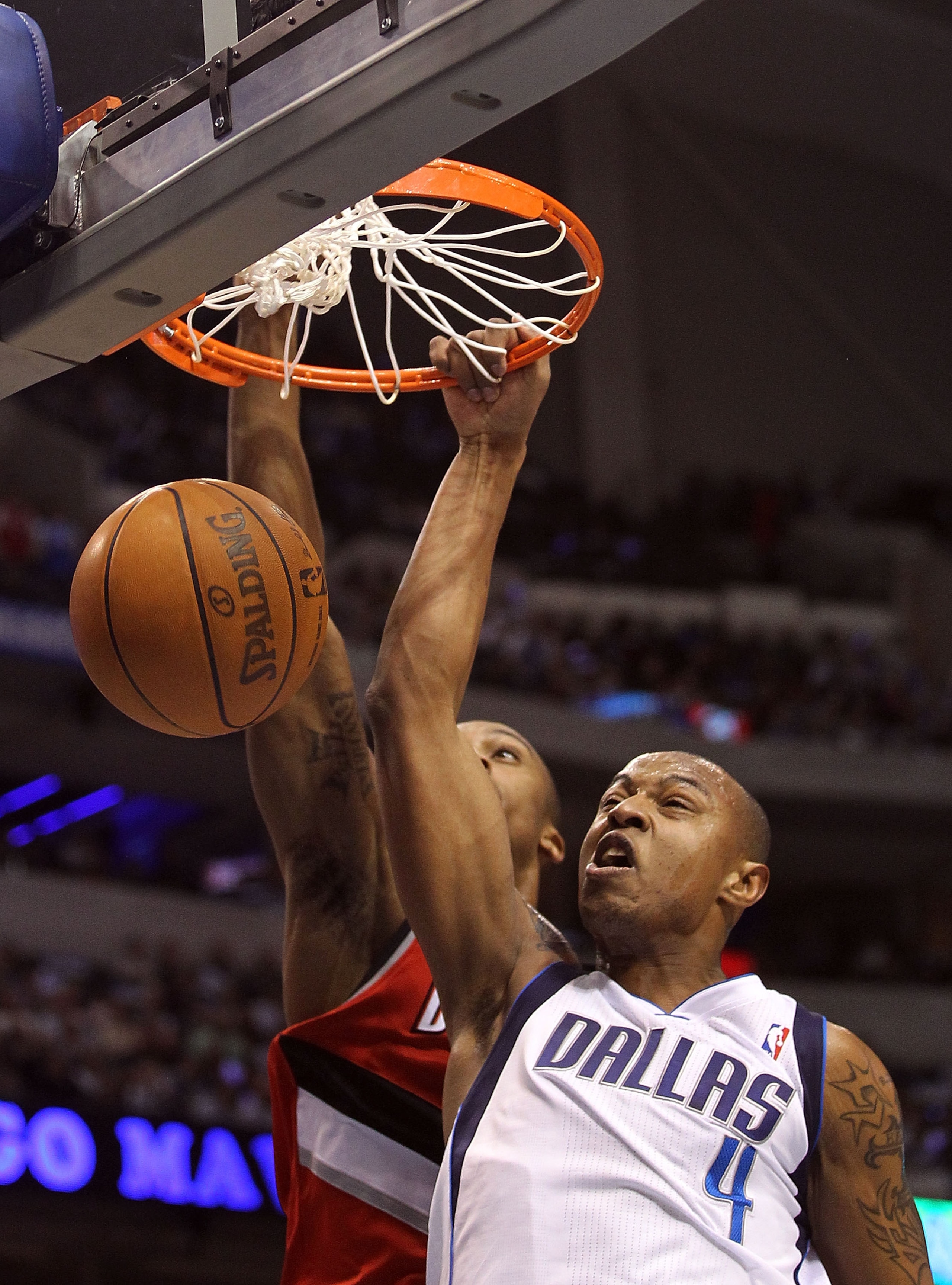 DALLAS, TX - DECEMBER 15:  Forward Caron Butler #4 of the Dallas Mavericks makes a slam dunk against Dante Cunningham #33 of the Portland Trail Blazers at American Airlines Center on December 15, 2010 in Dallas, Texas.  NOTE TO USER: User expressly acknow