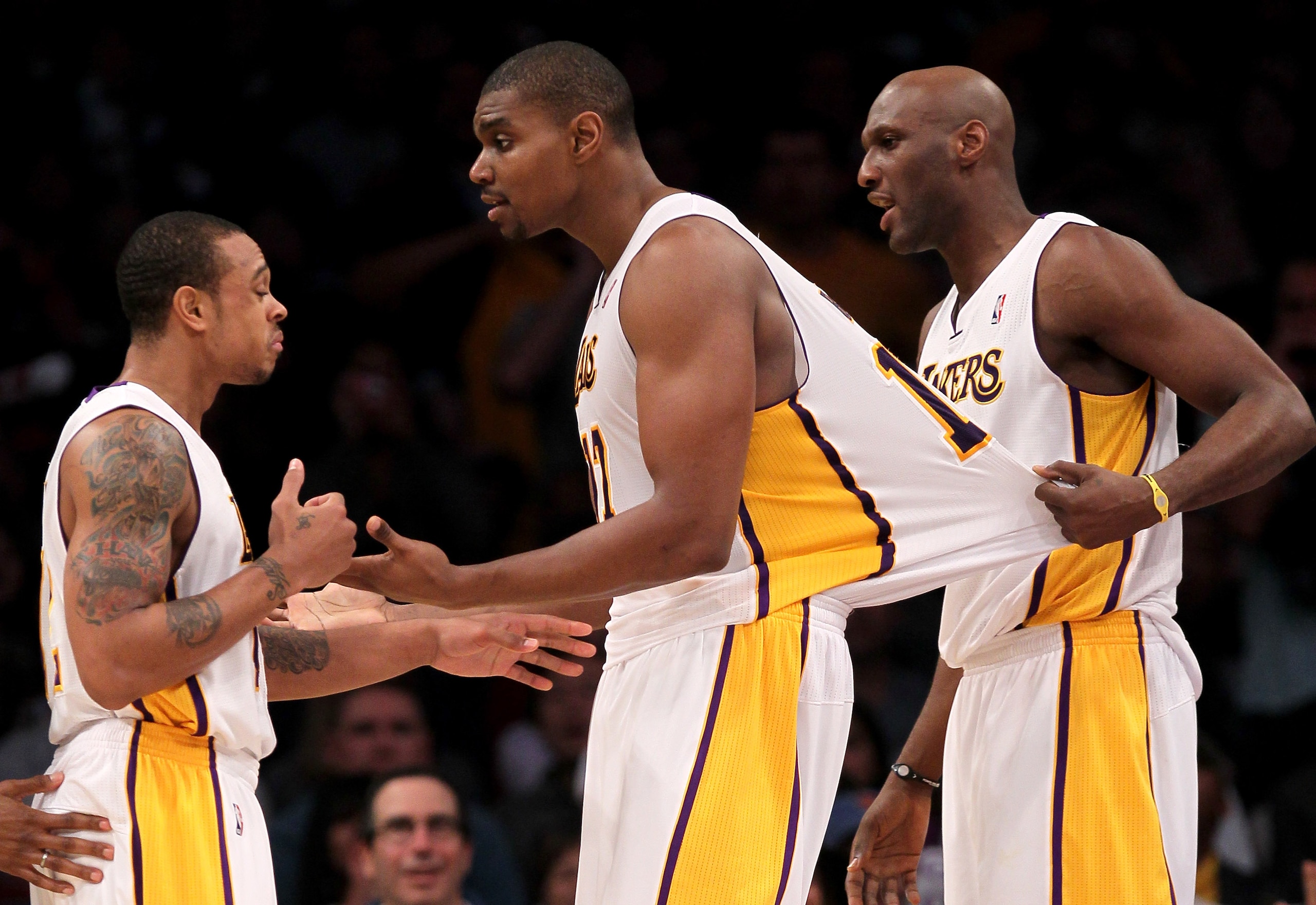 LOS ANGELES, CA - JANUARY 9: Andrew Bynum #17 (C) of the Los Angeles Lakers is restrained as he attempts to complain to a referee by Lamar Odom #7 (R) and Shannon Brown #12 in the game against the New York Knicks at Staples Center on January 9, 2011 in Lo