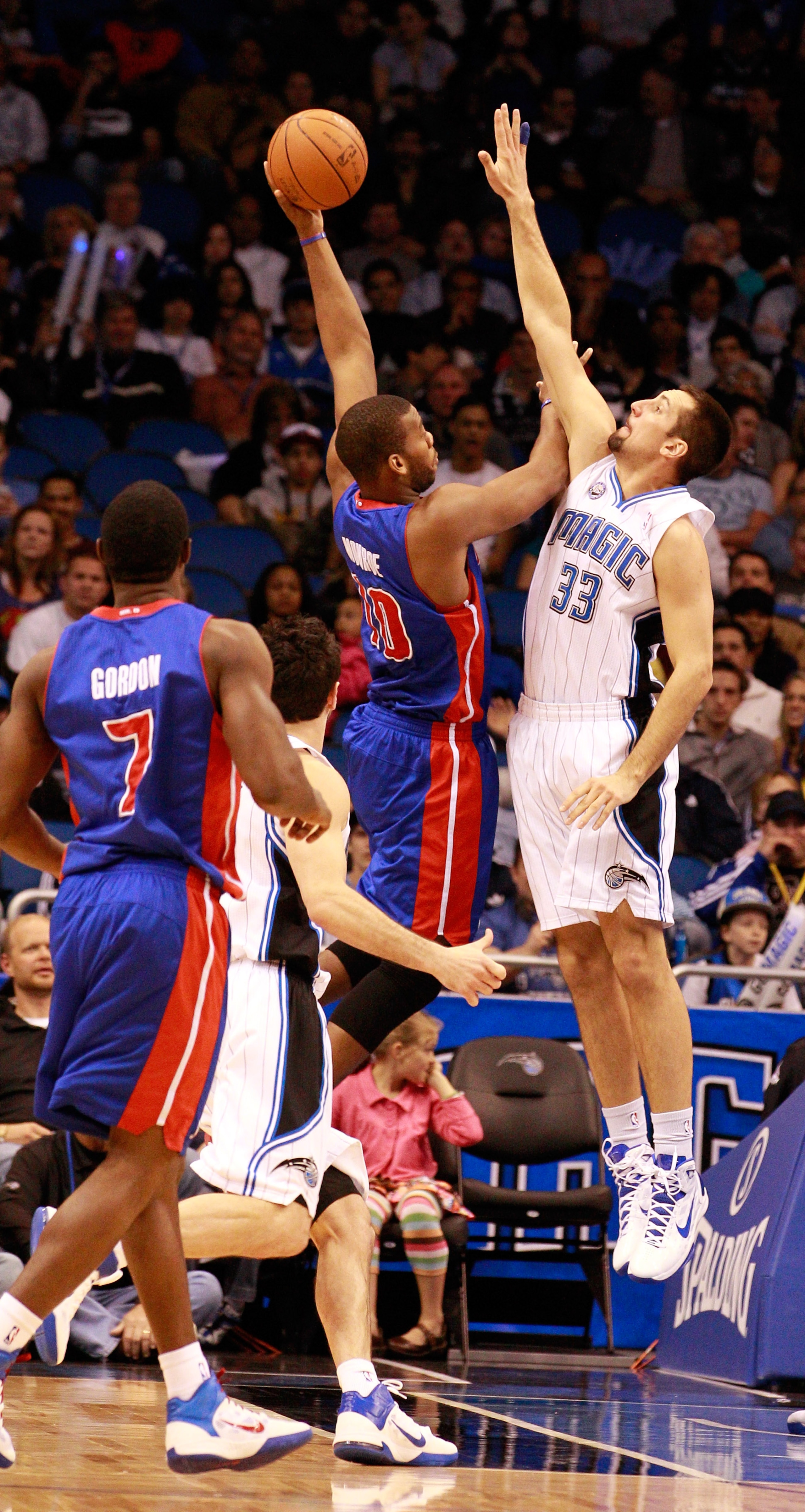 ORLANDO, FL - JANUARY 24:  Greg Monroe #10 of the Detroit Pistons attempts a shot over Ryan Anderson #33 of the Orlando Magic during the game at Amway Arena on January 24, 2011 in Orlando, Florida.  NOTE TO USER: User expressly acknowledges and agrees tha
