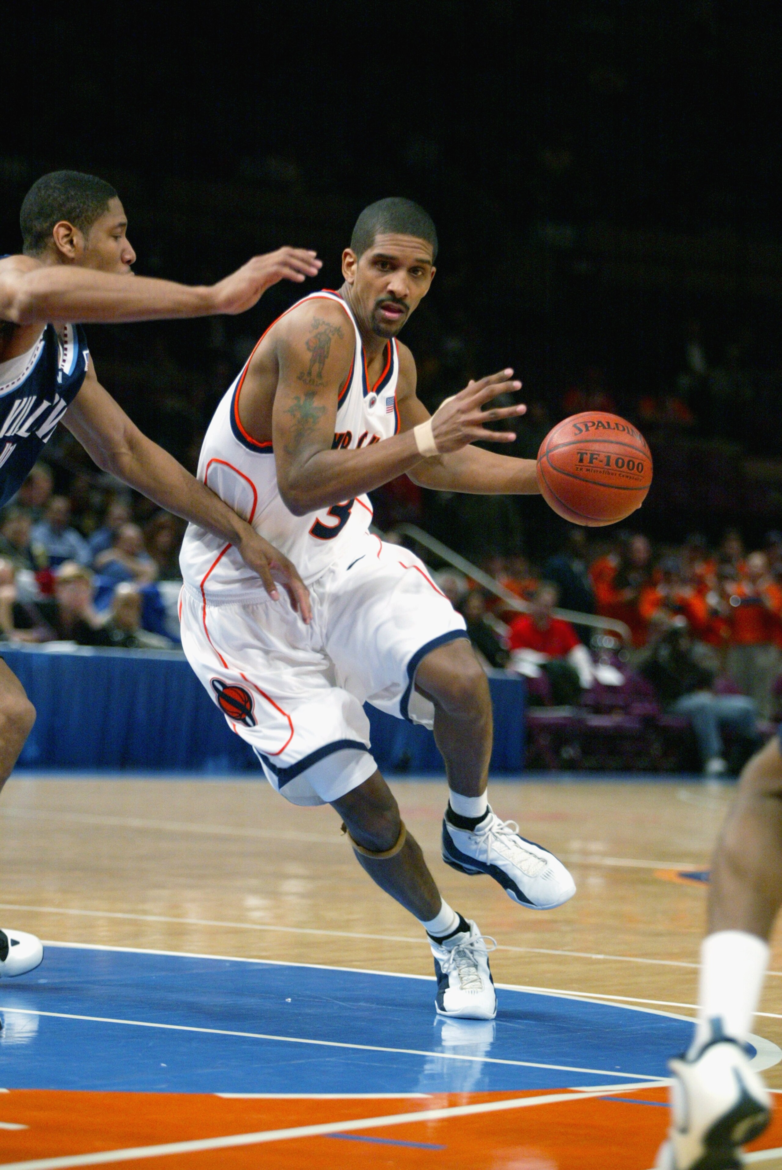 NEW YORK - MARCH 6:  Guard Preston Shumpert #3 of the Syracuse Orangemen is pressured as he drives to the basket during the first round of the Big East Championship  against the Villanova Wildcats at Madison Square Garden in New York, New York on March 6,