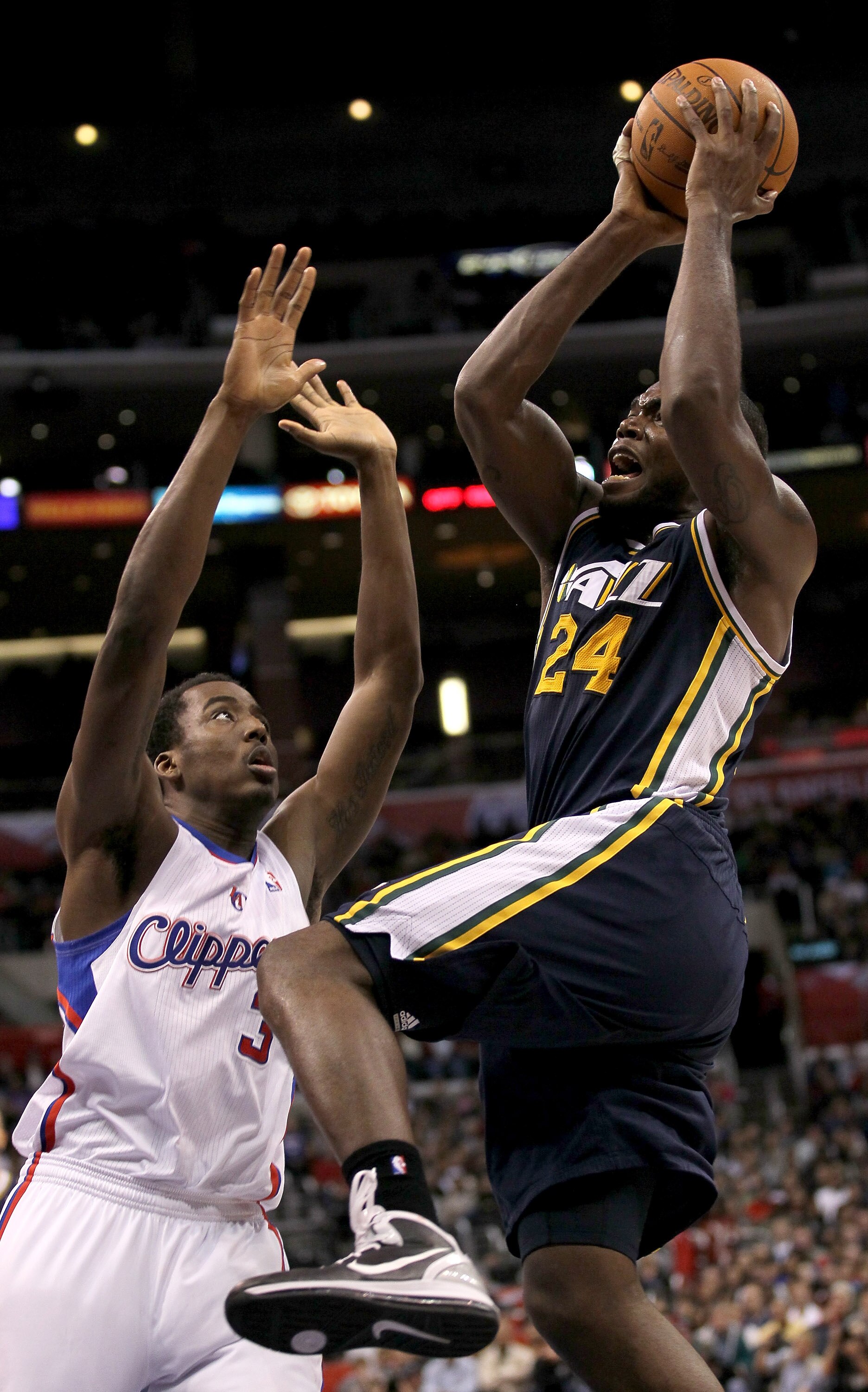 LOS ANGELES, CA - DECEMBER 29:  Paul Millsap #24 of the Utah Jazz shoots over Al-Farouq Aminu #3 of the Los Angeles Clippers at Staples Center on December 29, 2010 in Los Angeles, California.   The Jazz won 103-85.  NOTE TO USER: User expressly acknowledg