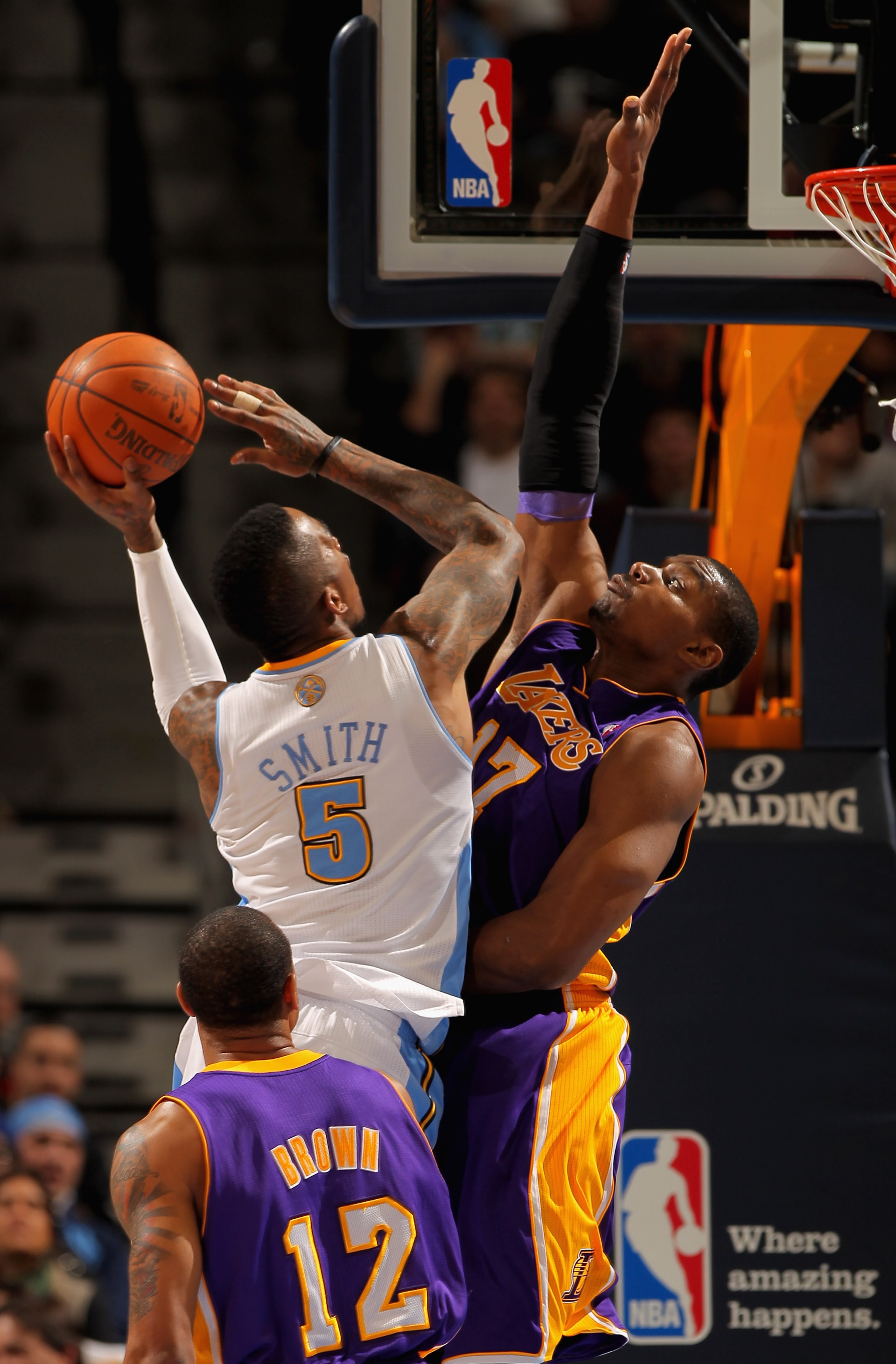 DENVER, CO - JANUARY 21: J.R. Smith #5 of the Denver Nuggets takes a shot against Andrew Bynum #17 of the Los Angeles Lakers at the Pepsi Center on January 21, 2011 in Denver, Colorado. NOTE TO USER: User expressly acknowledges and agrees that, by downlo DENVER, CO - JANUARY 21: J.R. Smith #5 of the Denver Nuggets takes a shot against Andrew Bynum #17 of the Los Angeles Lakers at the Pepsi Center on January 21, 2011 in Denver, Colorado. NOTE TO USER: User expressly acknowledges and agrees that, by downlo