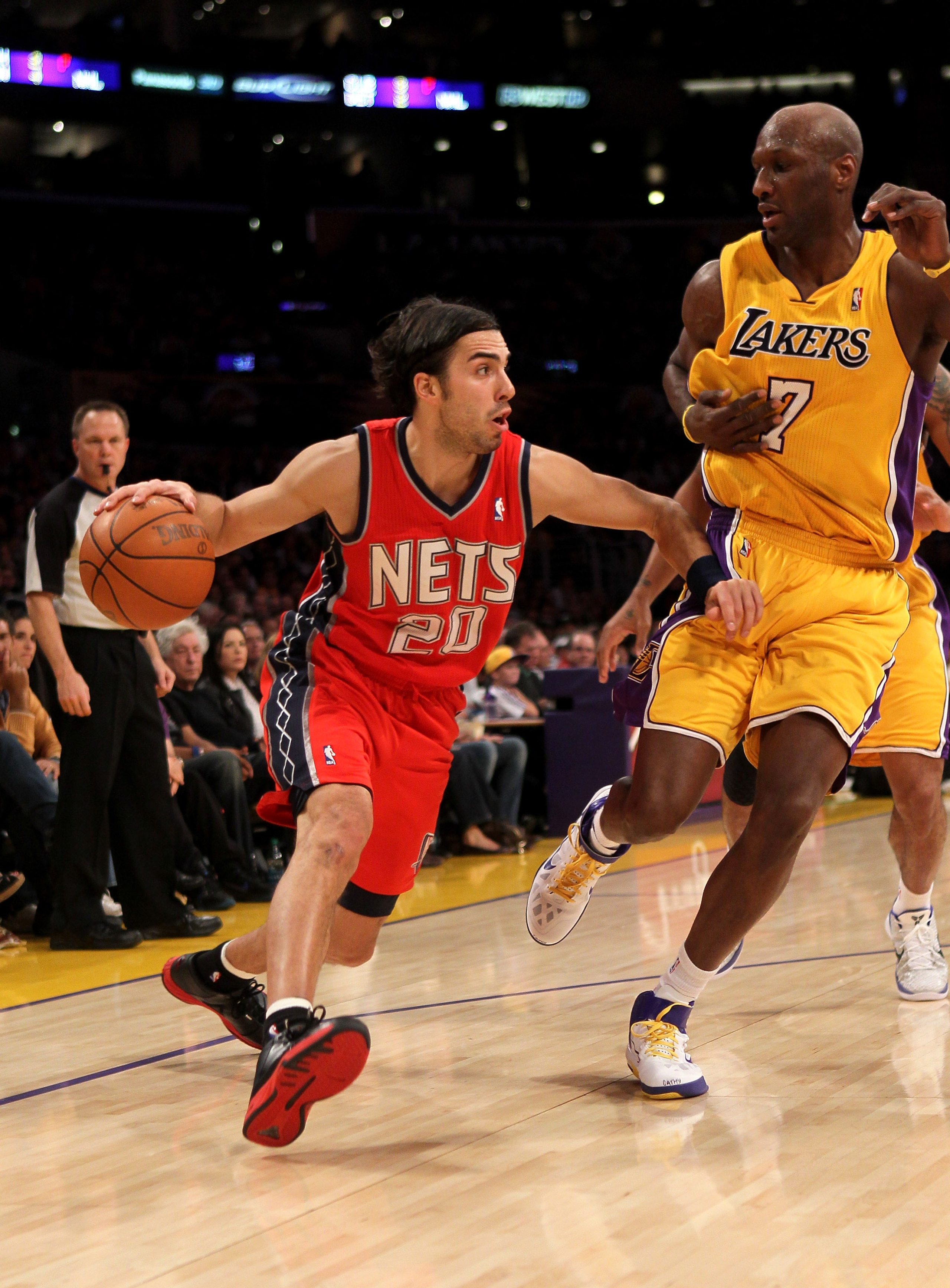 LOS ANGELES, CA - JANUARY 14: Sasha Vujacic #20 of the New Jersey Nets drives against Lamar Odom #7 of the Los Angeles Lakers at Staples Center on January 14, 2011 in Los Angeles, California. The Lakers won 100-88. NOTE TO USER: User expressly acknowled LOS ANGELES, CA - JANUARY 14: Sasha Vujacic #20 of the New Jersey Nets drives against Lamar Odom #7 of the Los Angeles Lakers at Staples Center on January 14, 2011 in Los Angeles, California. The Lakers won 100-88. NOTE TO USER: User expressly acknowled