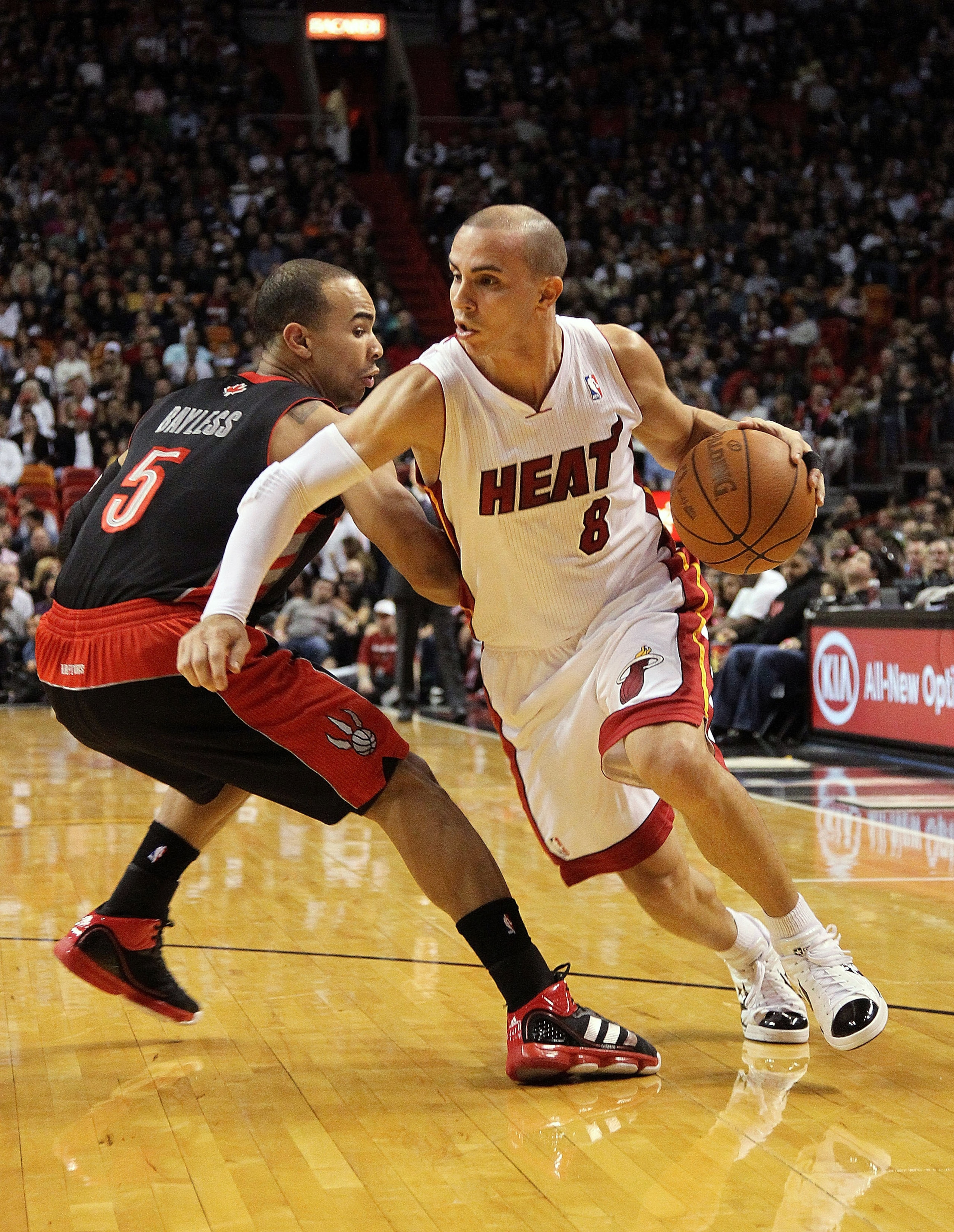 MIAMI, FL - JANUARY 22: Carlos Arroyo #8 of the Miami Heat dribbles by Jerryd Bayless #5 of the Toronto Raptors during a game at American Airlines Arena on January 22, 2011 in Miami, Florida. NOTE TO USER: User expressly acknowledges and agrees that, by MIAMI, FL - JANUARY 22: Carlos Arroyo #8 of the Miami Heat dribbles by Jerryd Bayless #5 of the Toronto Raptors during a game at American Airlines Arena on January 22, 2011 in Miami, Florida. NOTE TO USER: User expressly acknowledges and agrees that, by