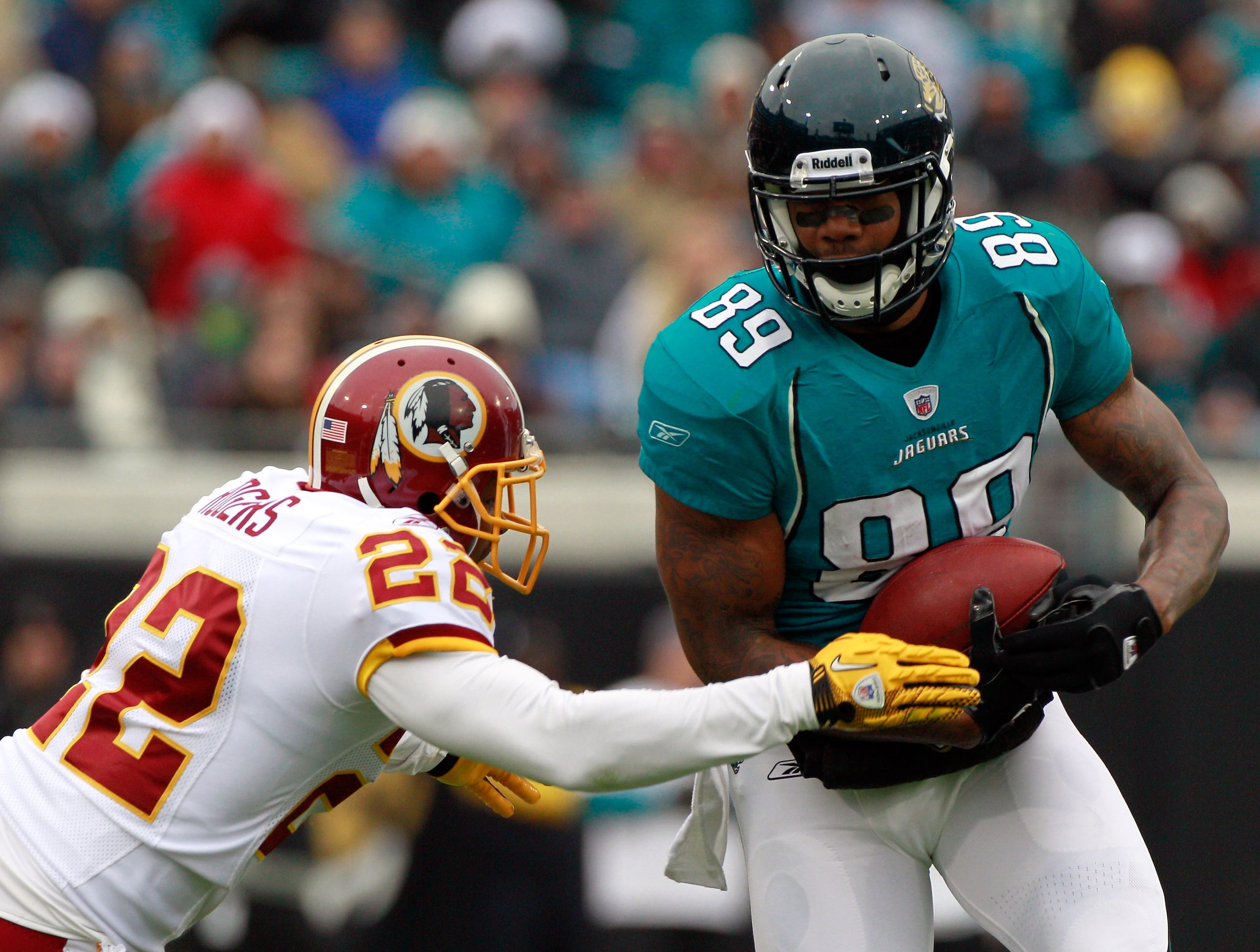 JACKSONVILLE, FL - DECEMBER 26:  Carlos Rogers #22 of the Washington Redskins attempts to tackle #89 Marcedes Lewis #89 of the Jacksonville Jaguars  during the game at EverBank Field on December 26, 2010 in Jacksonville, Florida.  (Photo by Sam Greenwood/