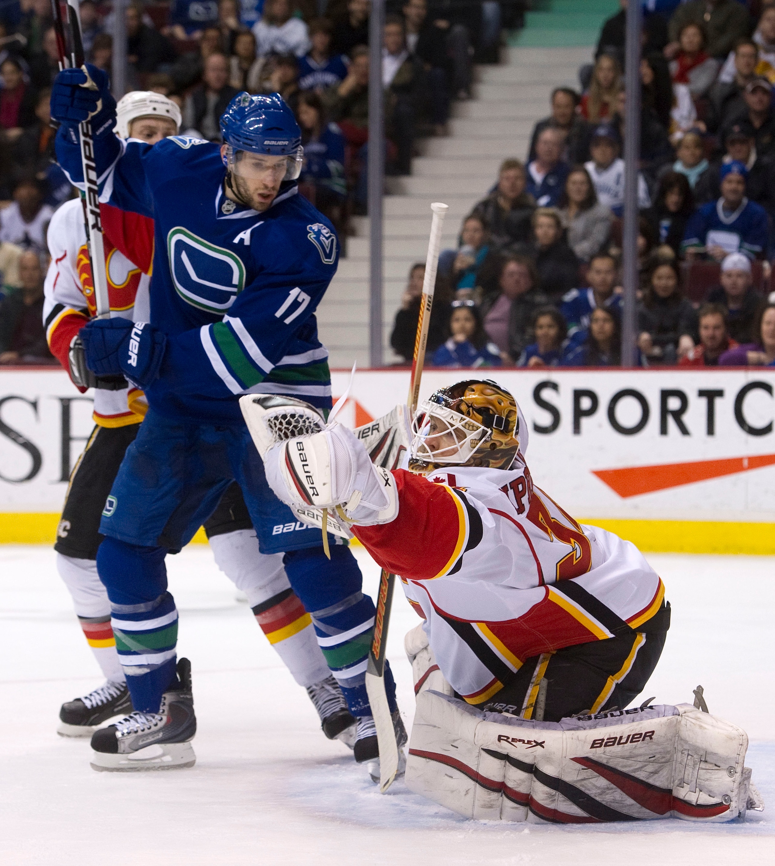 VANCOUVER, CANADA - JANUARY 22: Ryan Kesler #17 of the Vancouver Canucks watches goalie Miikka Kiprusoff #34 of the Calgary Flames make a glove save during the second period in NHL action on January 22, 2011 at Rogers Arena in Vancouver, British Columbia, VANCOUVER, CANADA - JANUARY 22: Ryan Kesler #17 of the Vancouver Canucks watches goalie Miikka Kiprusoff #34 of the Calgary Flames make a glove save during the second period in NHL action on January 22, 2011 at Rogers Arena in Vancouver, British Columbia,