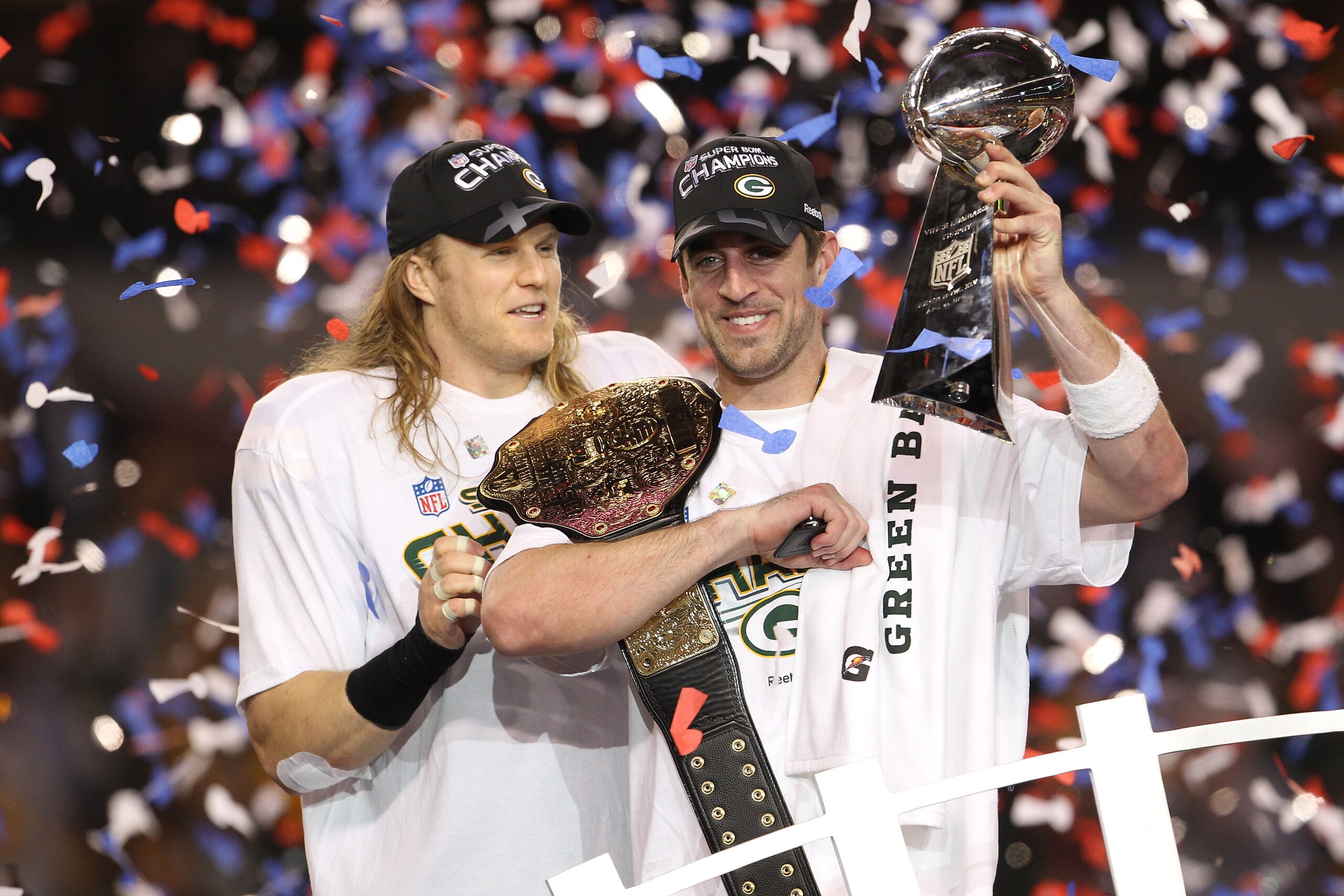 ARLINGTON, TX - FEBRUARY 06:  Aaron Rodgers #12 and Clay Matthews #52 of the Green Bay Packers of the Green Bay Packers holds the Lombardi Trophy after defeating the Pittsburgh Steelers 31-25 during Super Bowl XLV at Cowboys Stadium on February 6, 2011 in