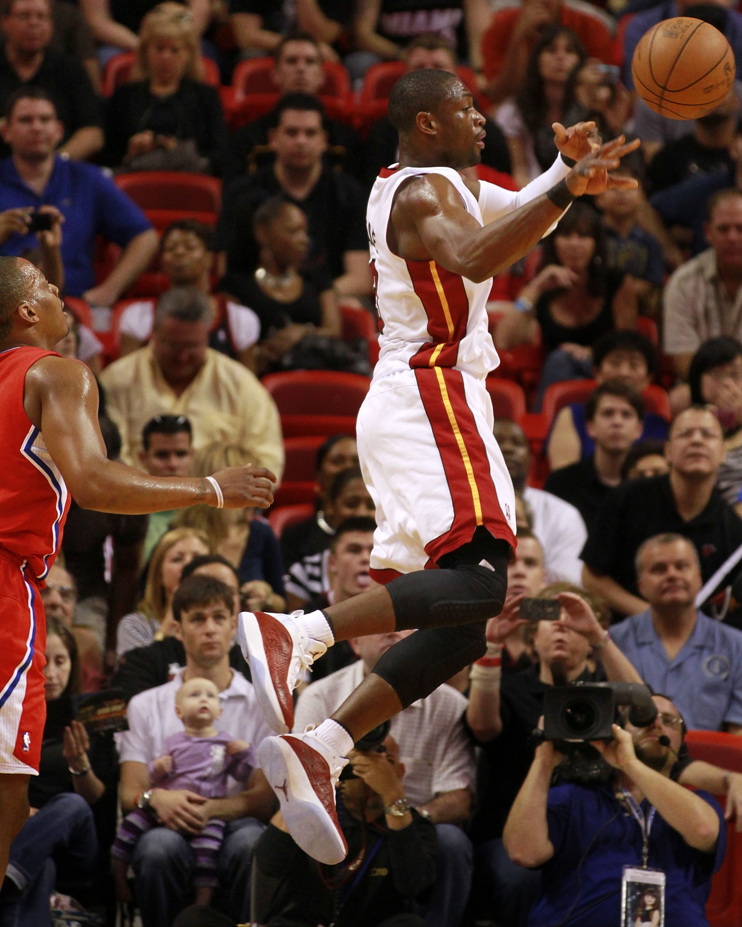 MIAMI, FL - FEBRUARY 06:  Guard Dwyane Wade #3 of the Miami Heat passes against the Los Angeles  Clippers at American Airlines Arena on February 6, 2011 in Miami, Florida.Miami defeated the Clippers 97-79. NOTE TO USER: User expressly acknowledges and agr