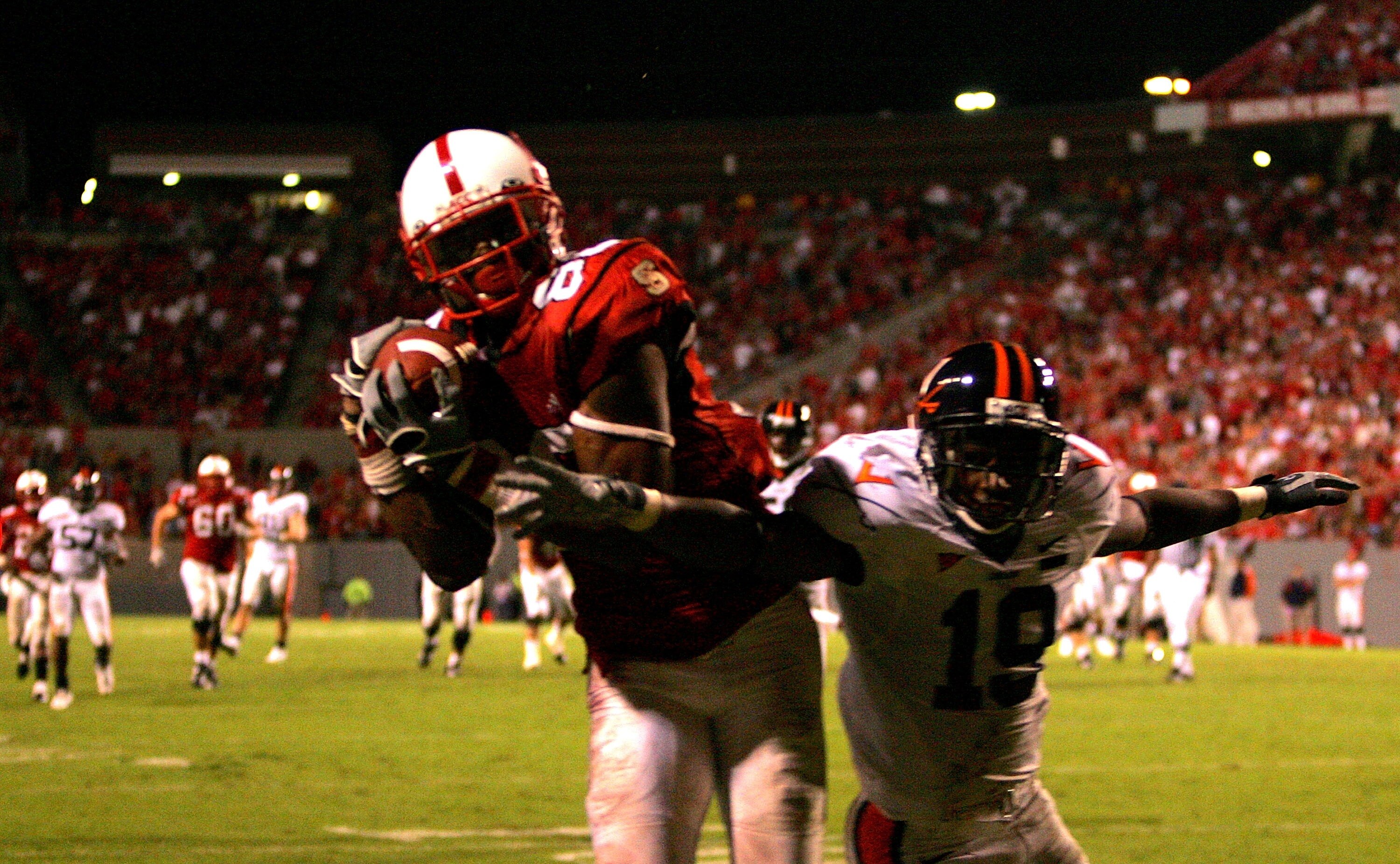 RALEIGH, NC - OCTOBER 27:  Ras-I Dowling #19 of the Virginia Cavaliers tries to stop Donald Bowens #80 of the North Carolina State Wolfpack as he catches the game-winning touchdown during their game at Carter-Finley Stadium October 27, 2007 in Raleigh, No